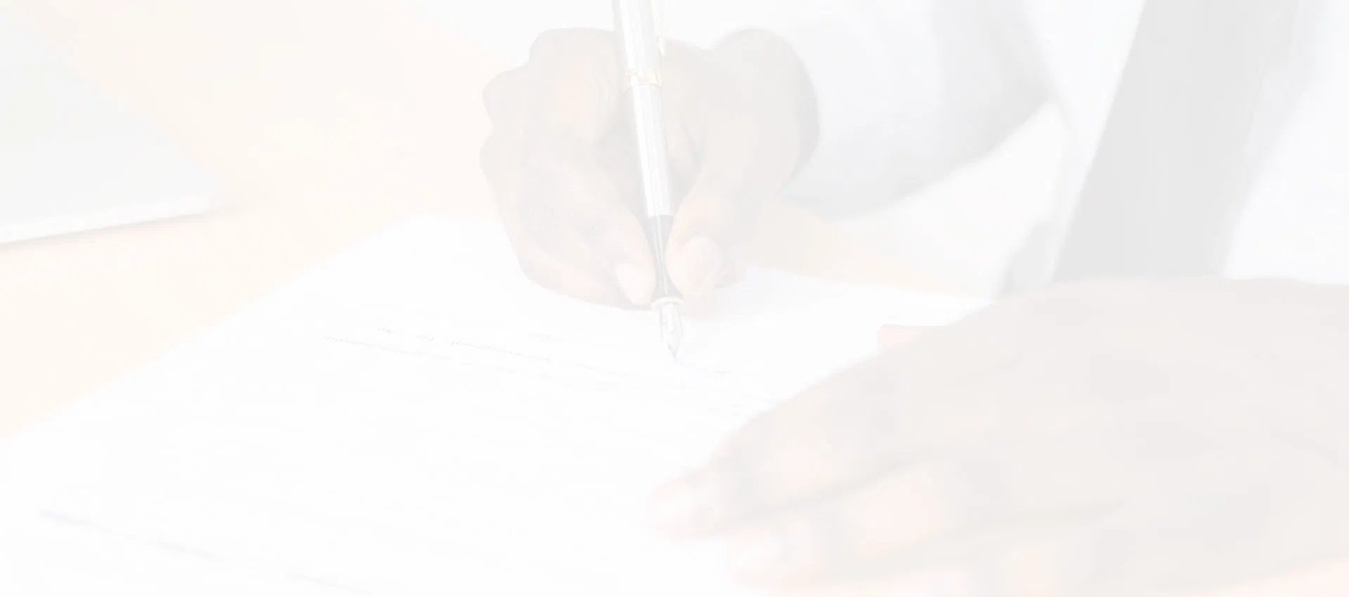 A hand signing the final application documents, signifying the official start of the citizenship process.