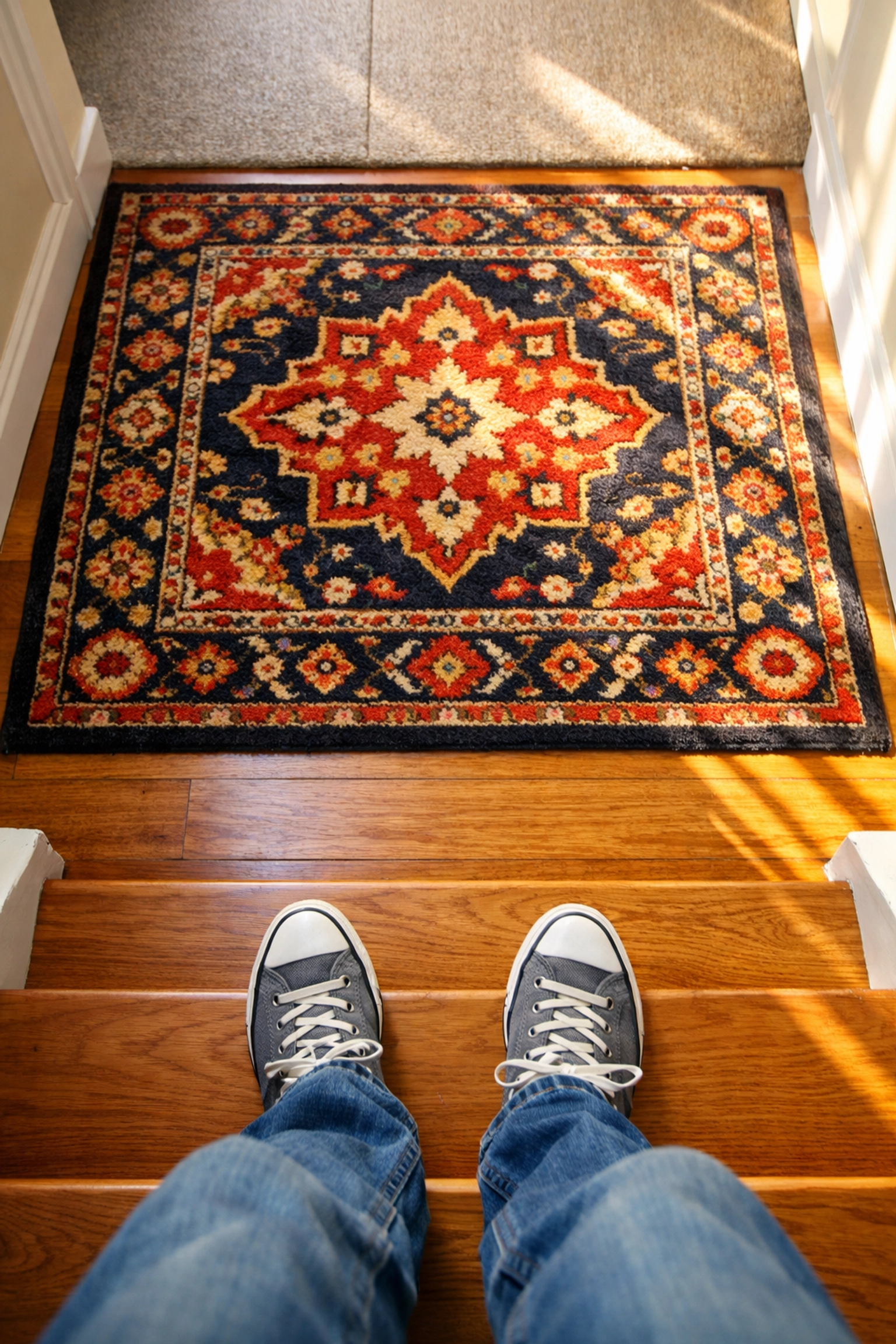 A contrast area rug placed at the bottom of stairs to help identify the landing and prevent missteps.