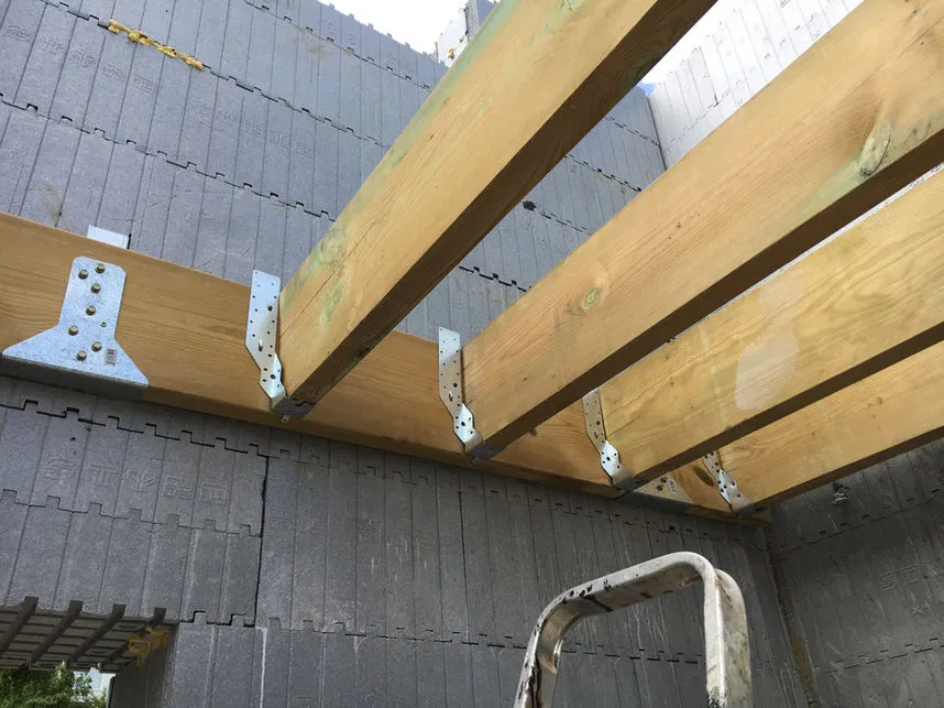 Exposed timber beams and joists demonstrating the precise integration of architectural and structural elements