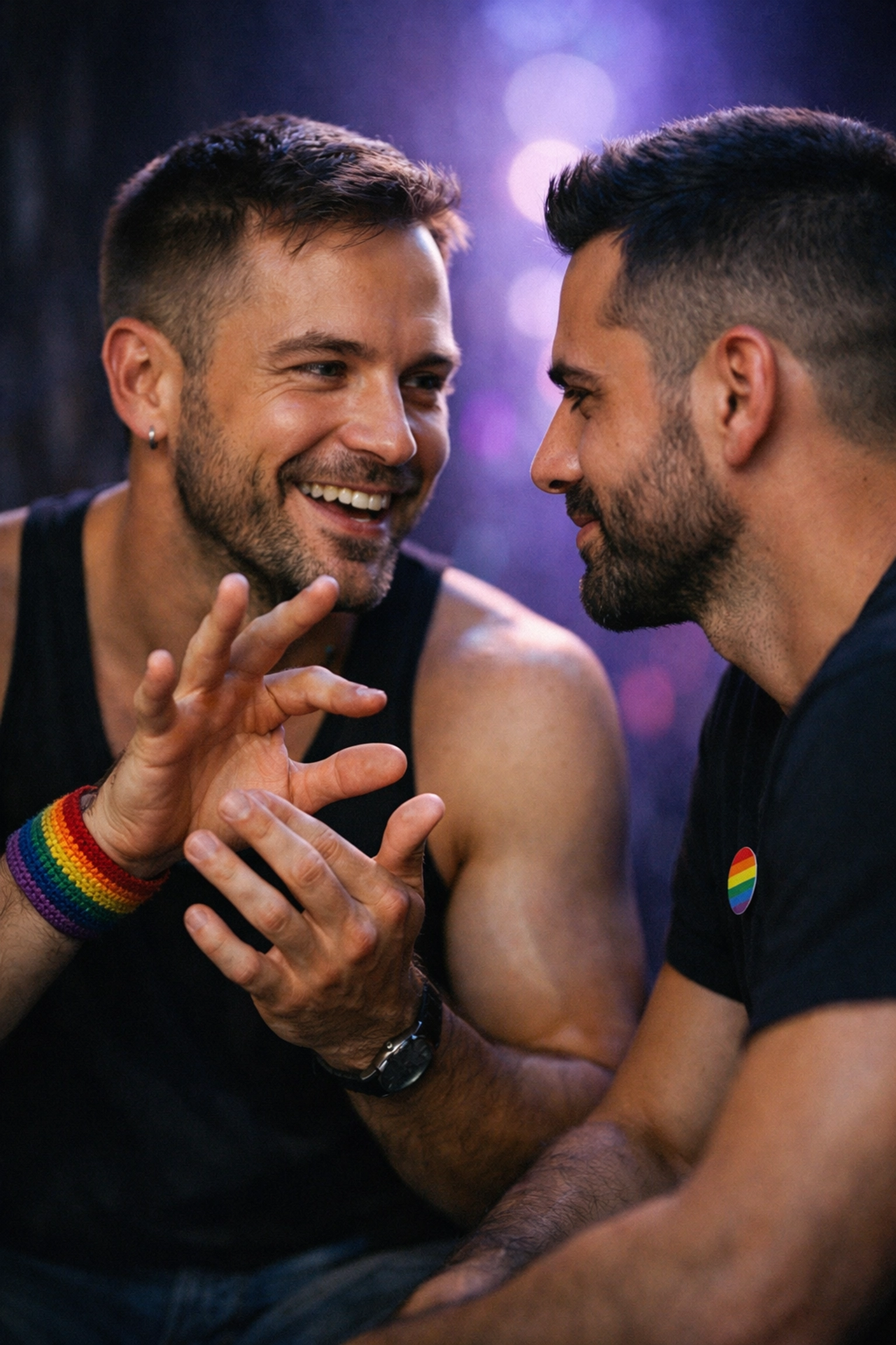 Two gay men using American Sign Language at a Pride event, highlighting communication accessibility for disabled attendees.