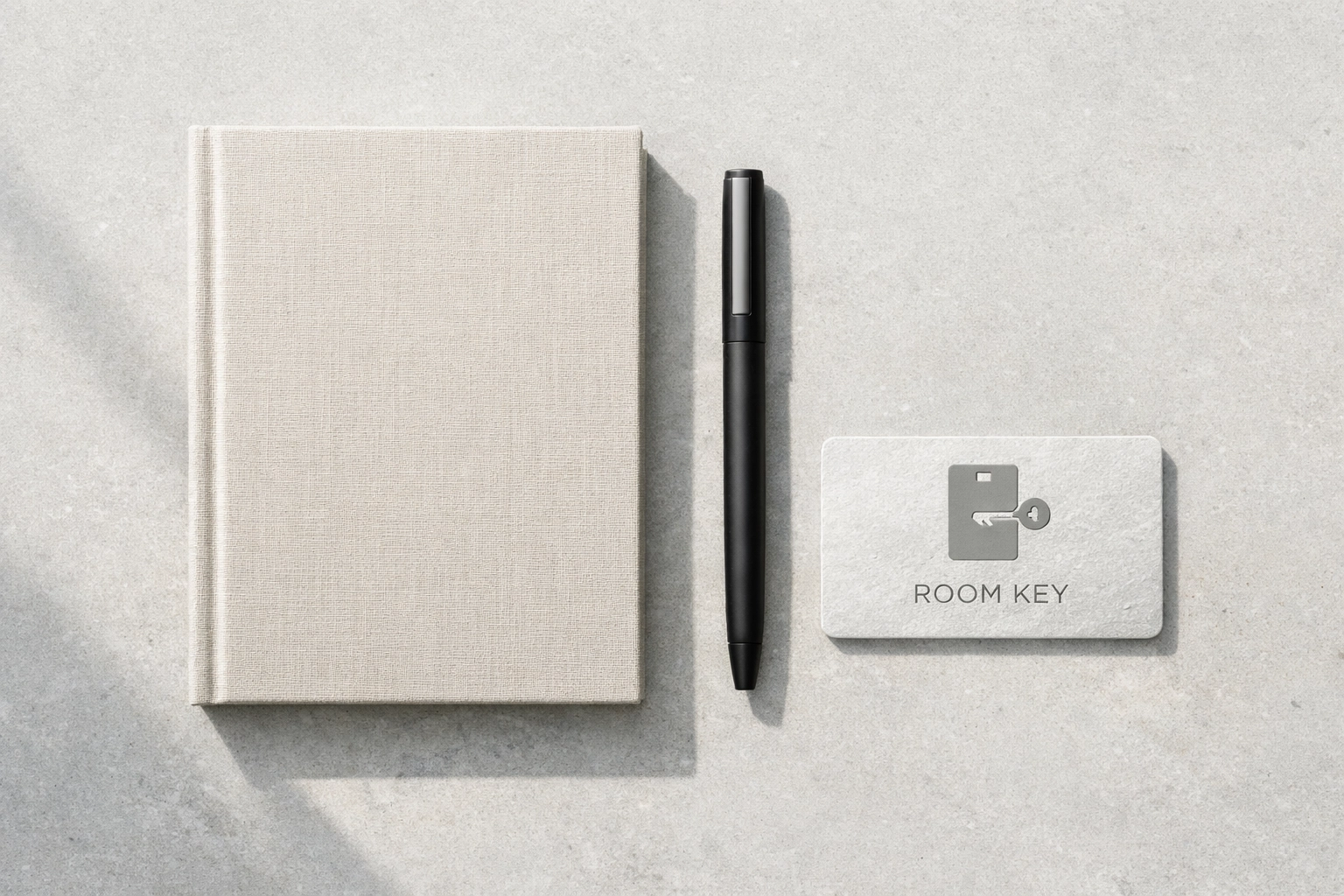 Minimalist flat-lay with a modern room key and notebook for hospitality success planning.