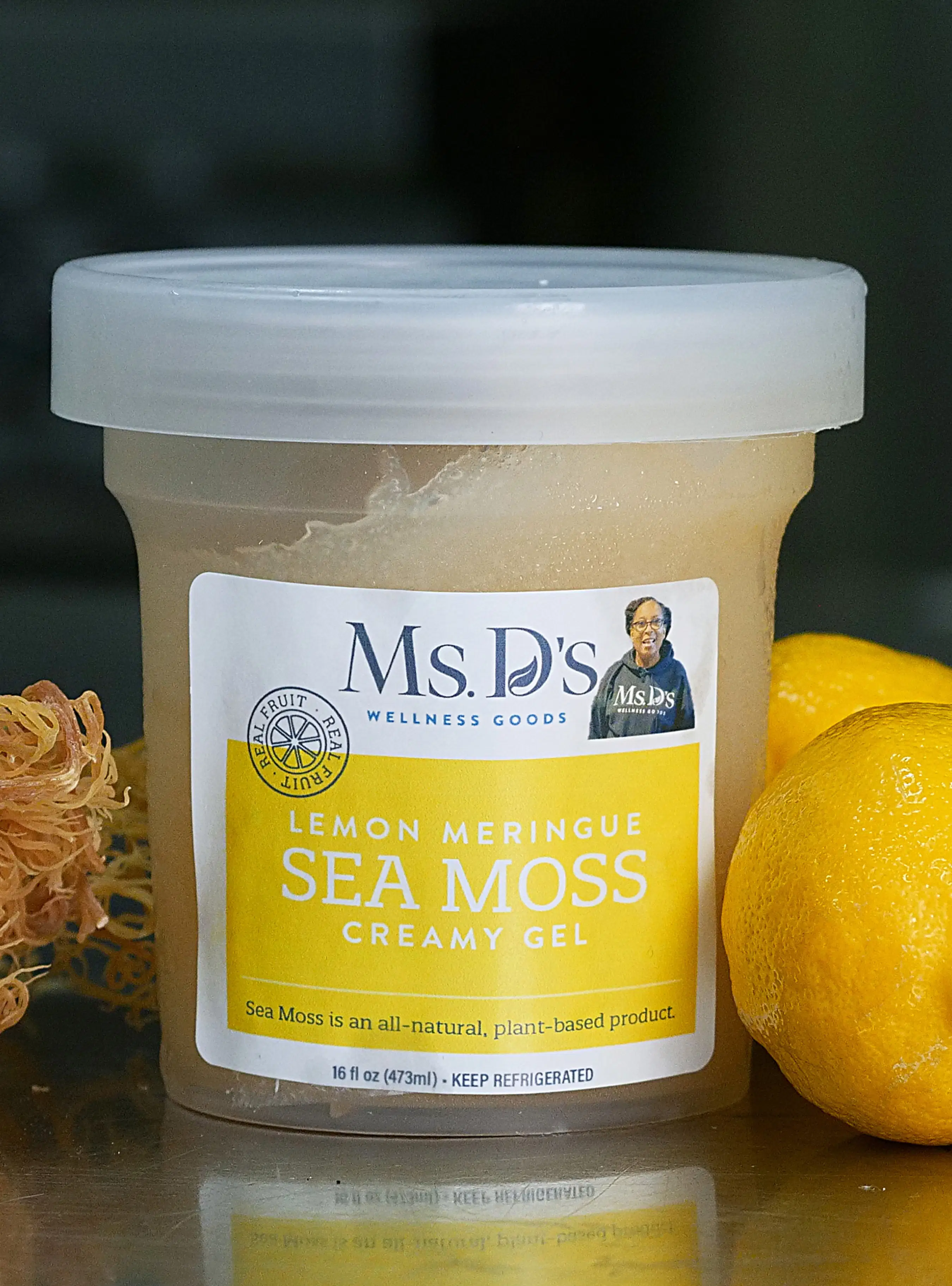 Close-up shot of Ms. D’s Lemon Meringue Sea Moss Creamy Gel 16oz jar featuring fresh lemons and raw gold sea moss
