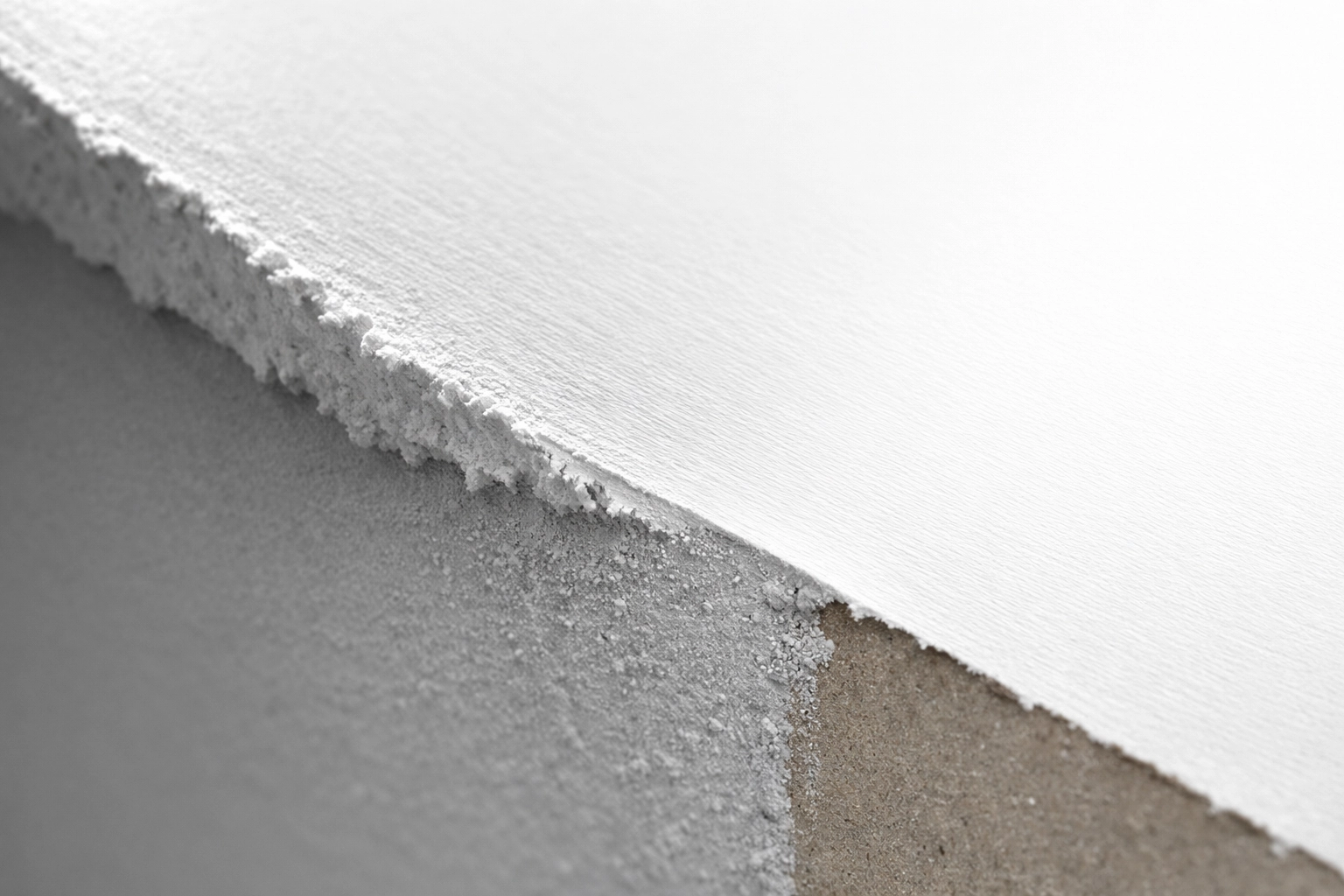 Close-up of feathered drywall edge showing smooth transition from compound to surface