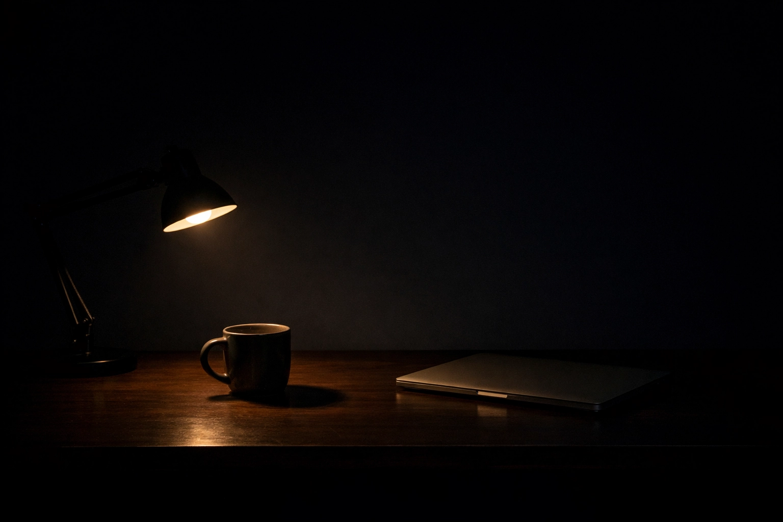 Minimalist dark desk at night representing the hidden costs and vacancy of SDR turnover.