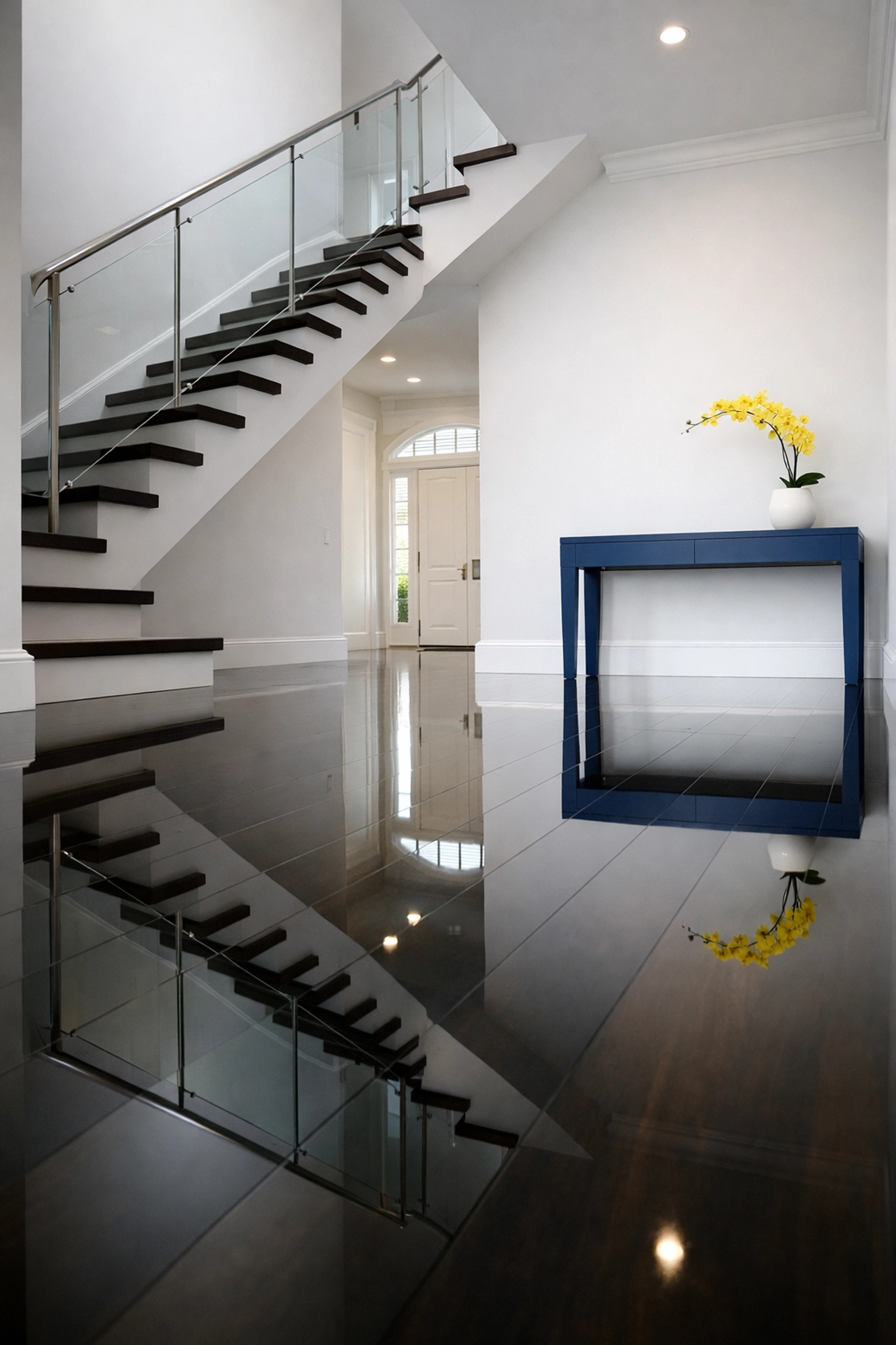 Polished dark hardwood floors in a Scituate home entryway, showcasing expert luxury residential cleaning.