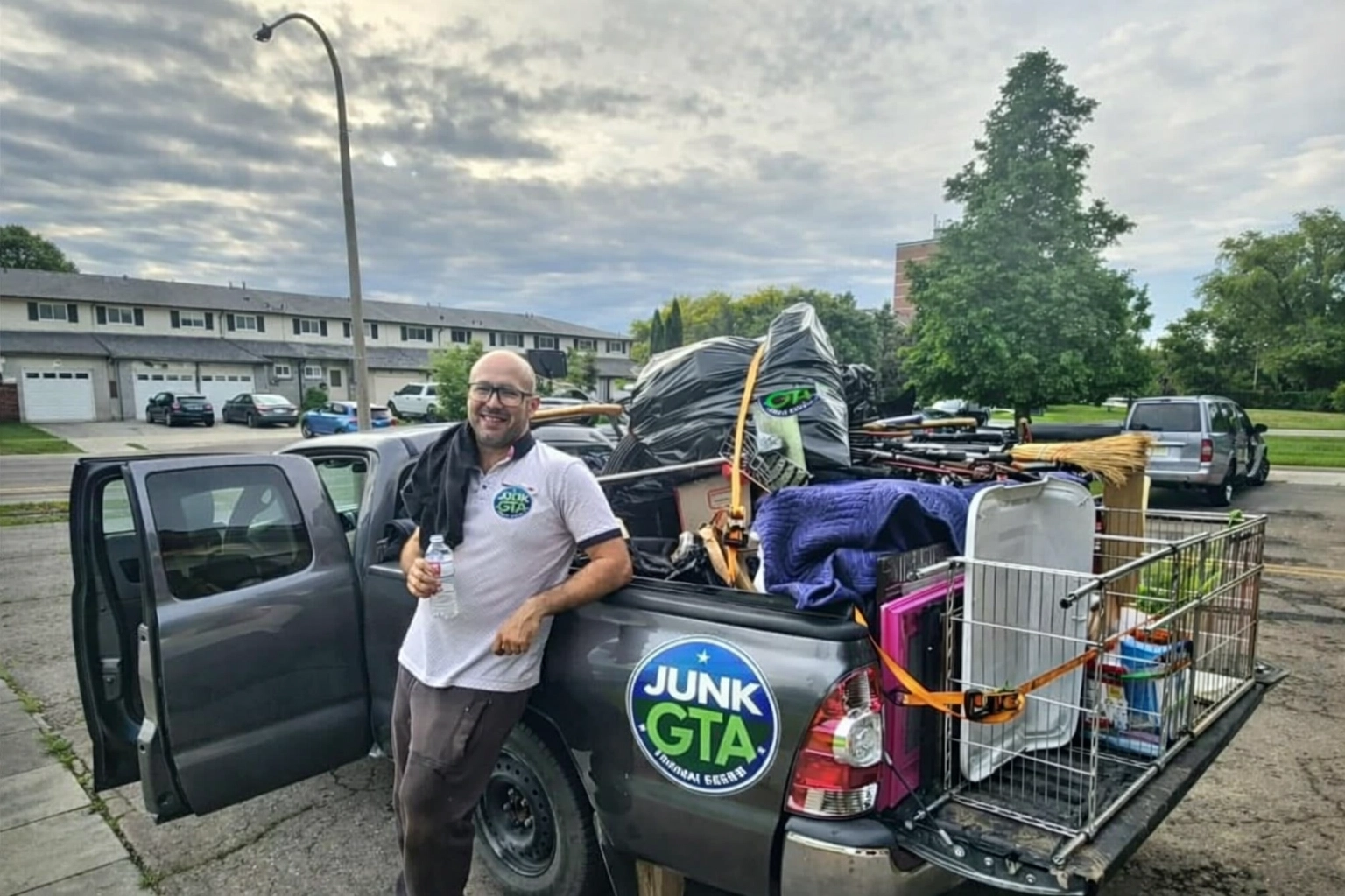 Office Decommissioning Richmond Hill: Sustainable Business Liquidation Junk GTA crew member with a full load in a residential area