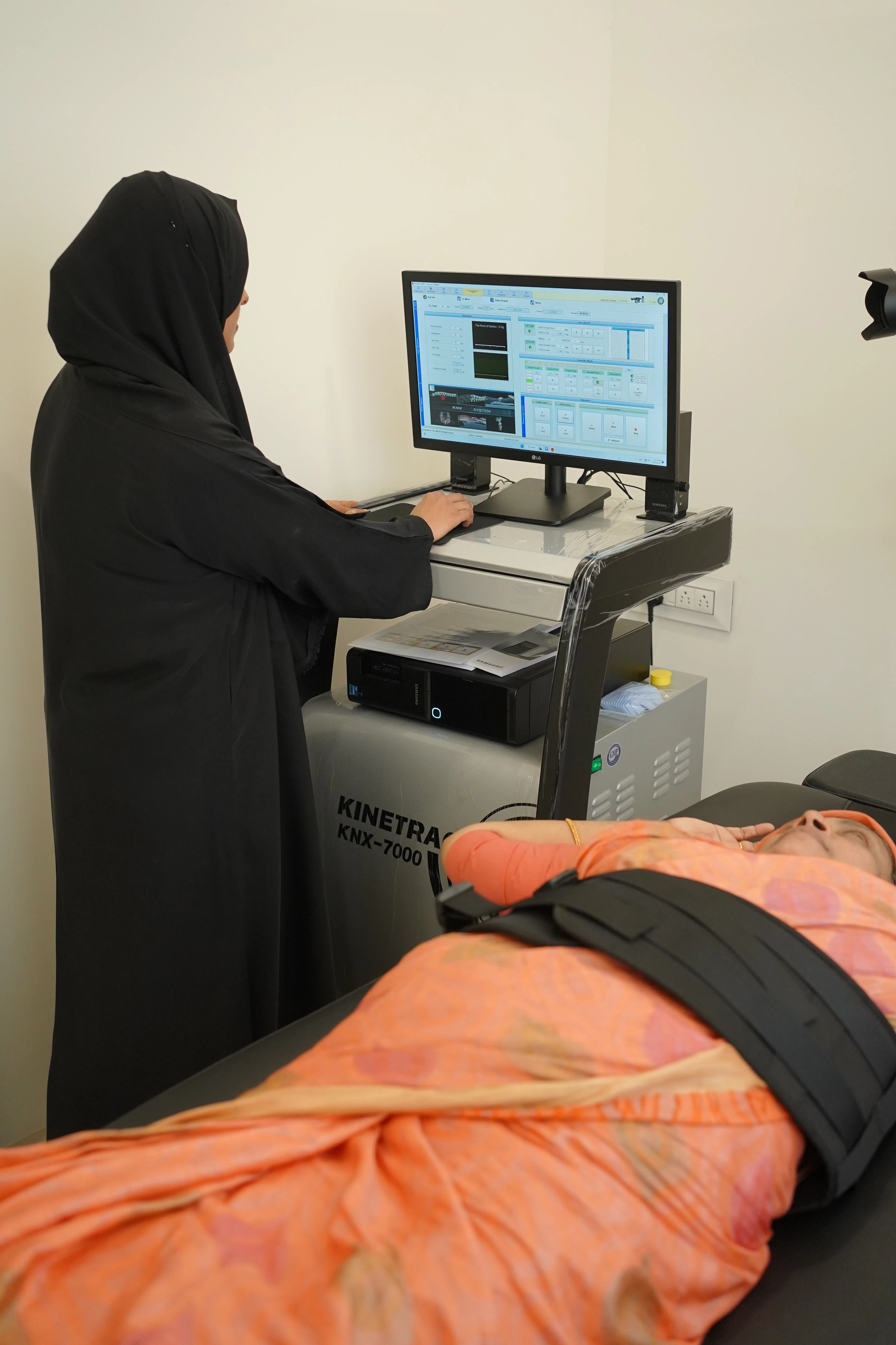 A patient receiving advanced spinal decompression therapy on the Kinetra KNX-7000 machine at Maana Health Perinthalmanna.