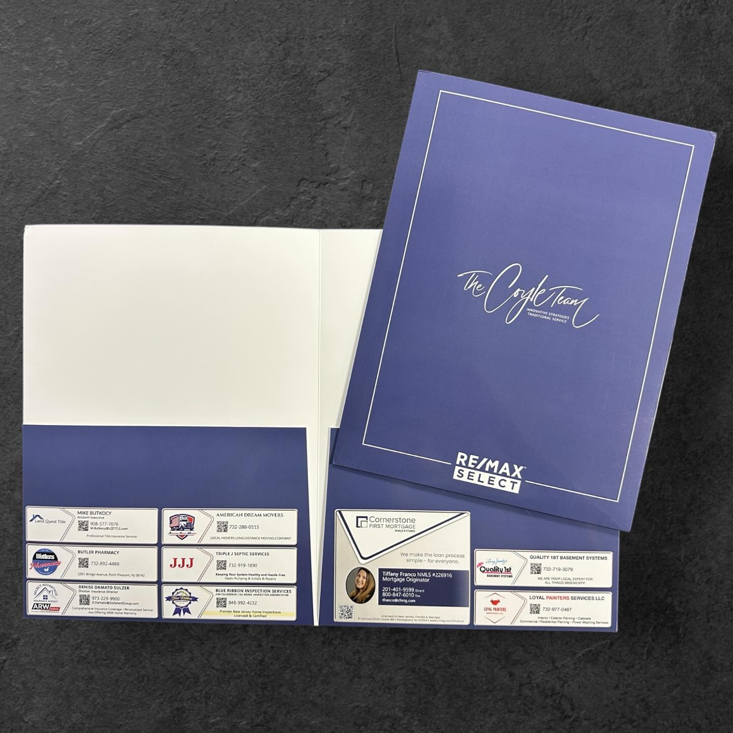 Custom-branded real estate presentation folders for 'The Coyle Team' at RE/MAX Select