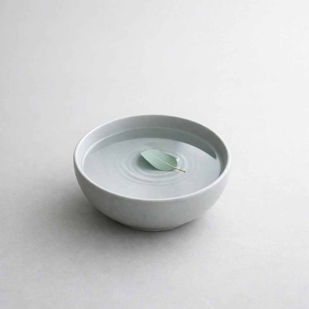 A serene bowl of water and leaf symbolizing mental fitness and burnout prevention for LGBTQ+ executives.