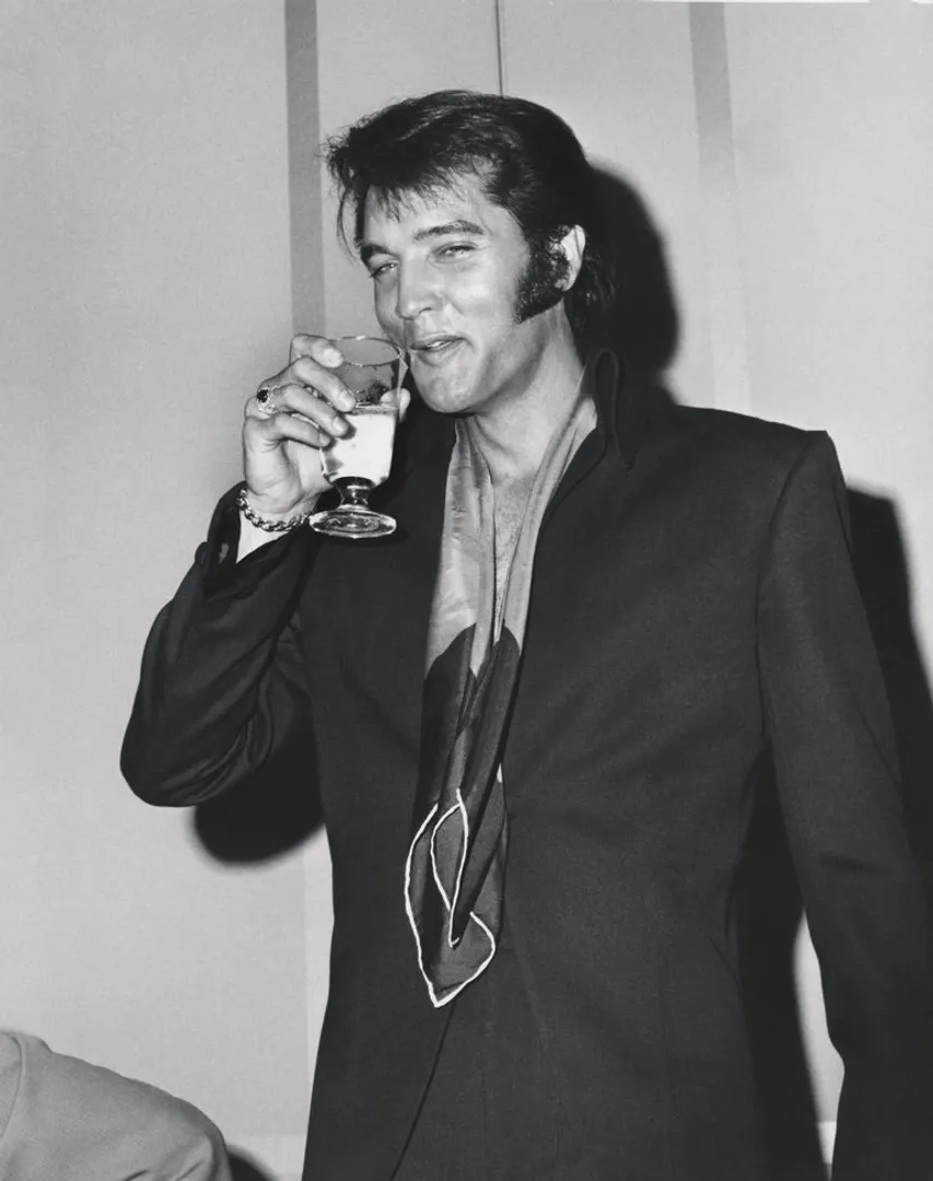 Elvis Presley smiling candidly in a suit