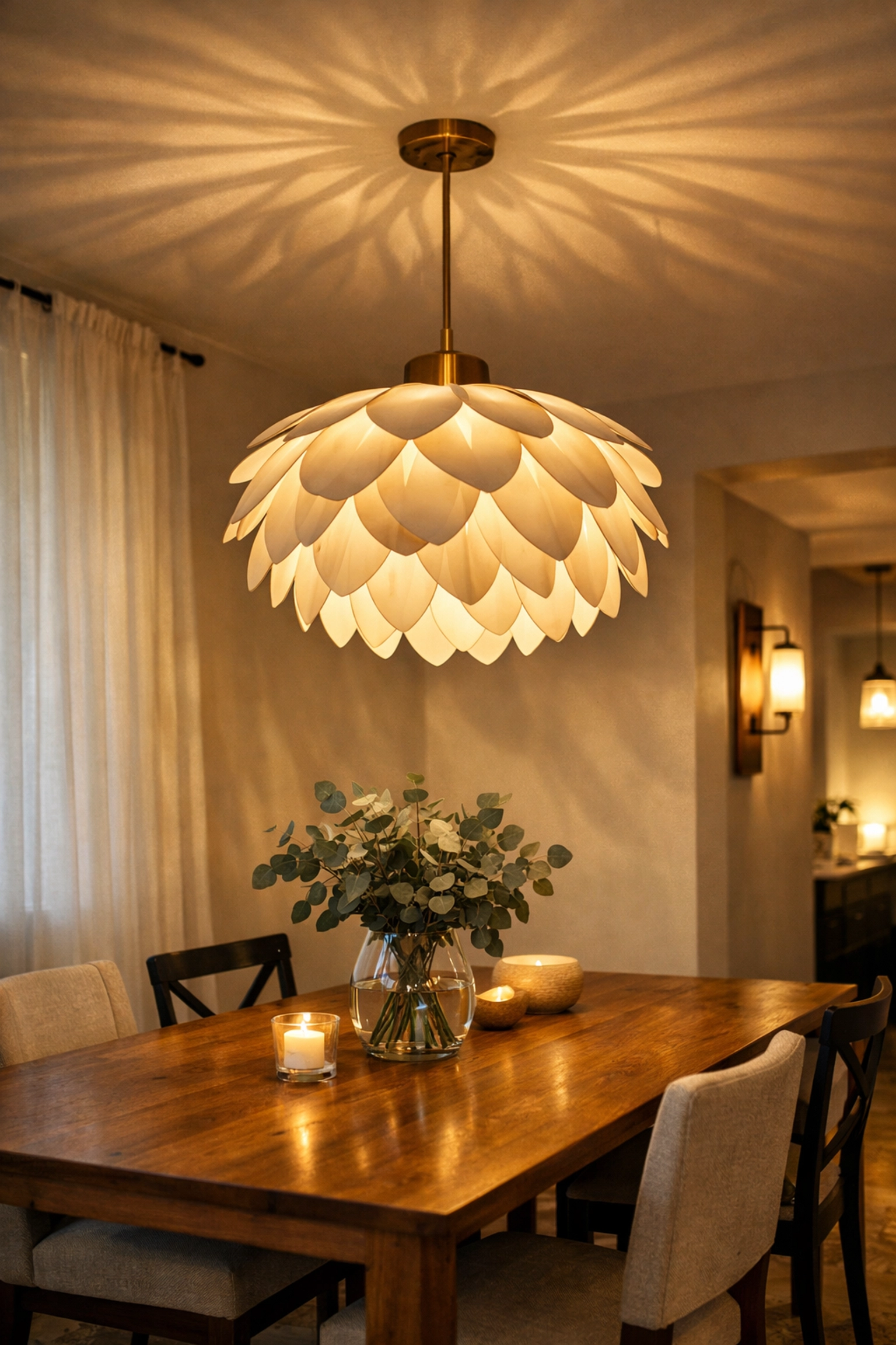 Modern pendant light fixture creating warm ambiance over dining room table