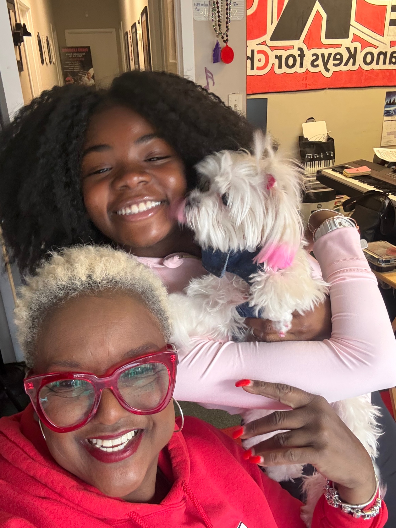 Smiling staff and student inside Piano Keys for Christ studio