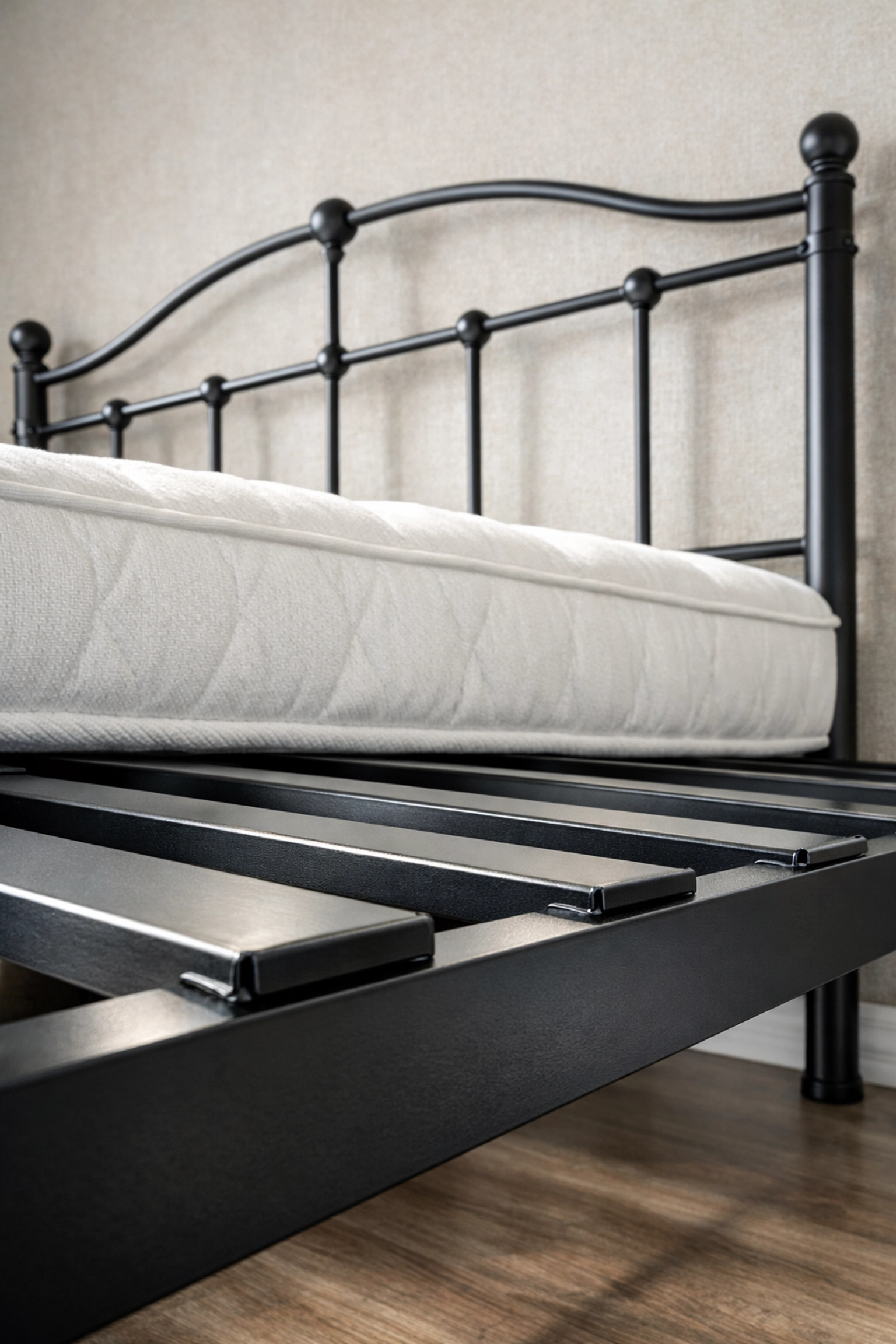 Detail of a sturdy metal platform bed frame showing support slats for a no-demo bedroom refresh.