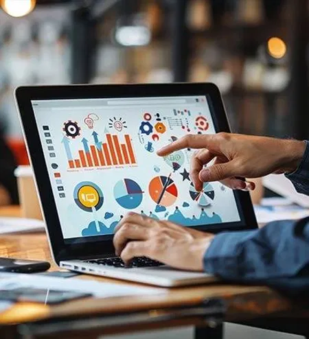 Hands using laptop analytics dashboard for school insights