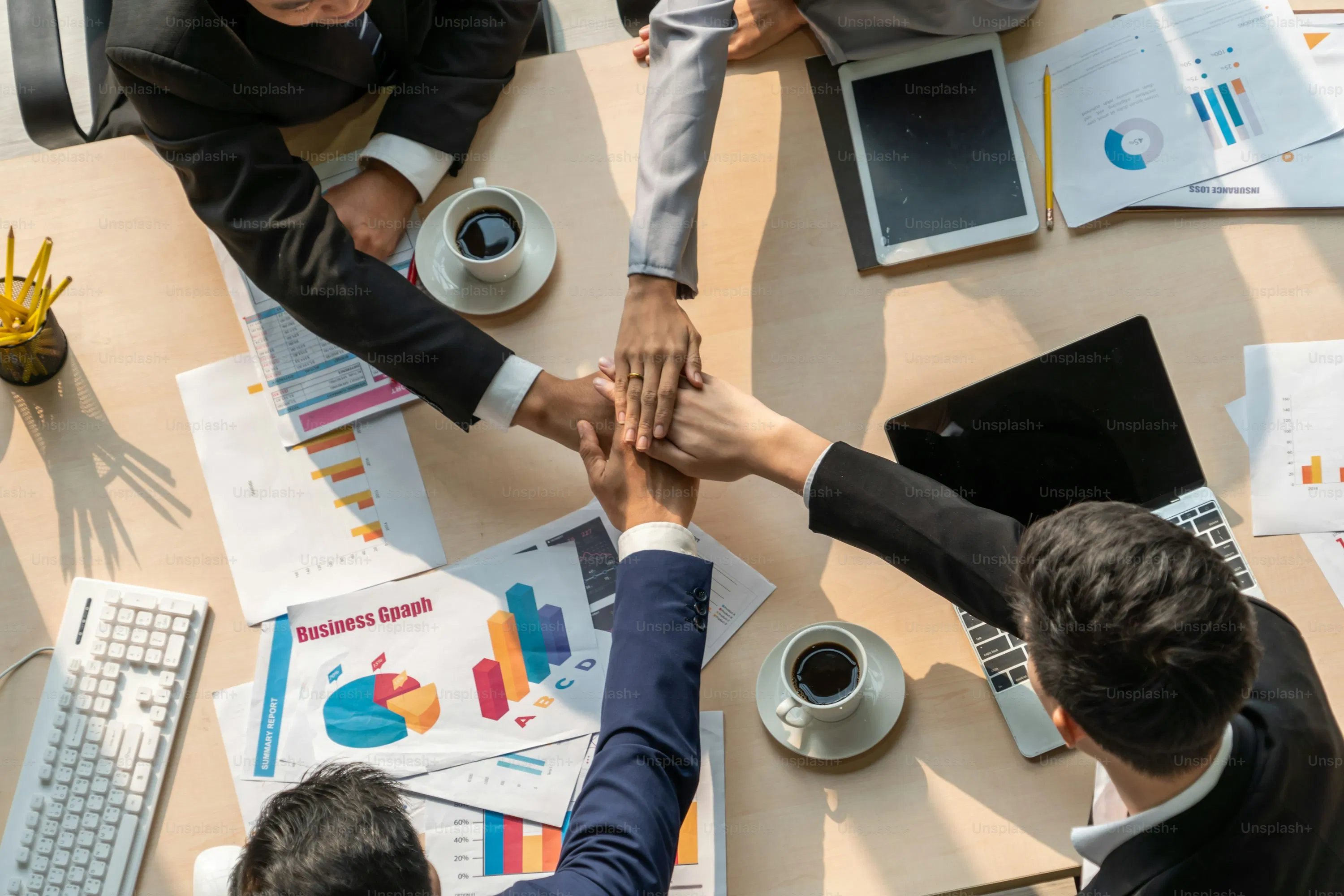 A diverse group of professionals collaborating around a desk with financial reports
