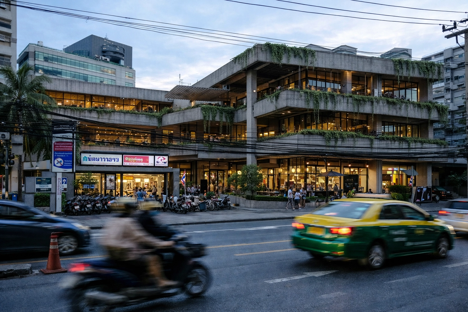 Modern exterior of a creative workspace and community hub in Bangkok's Thonglor district.