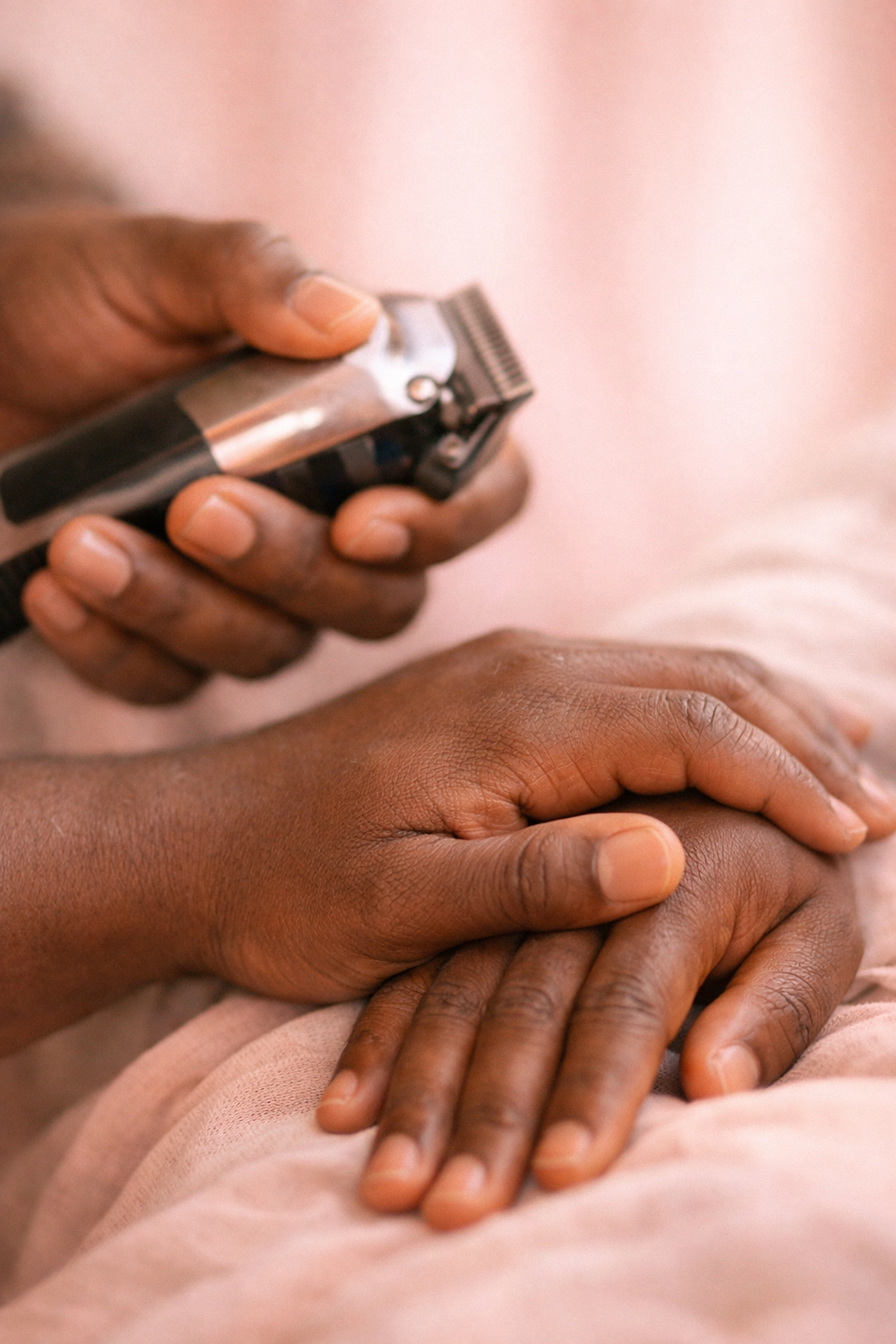 Barber's hands holding clippers showing trust and connection in mental health care