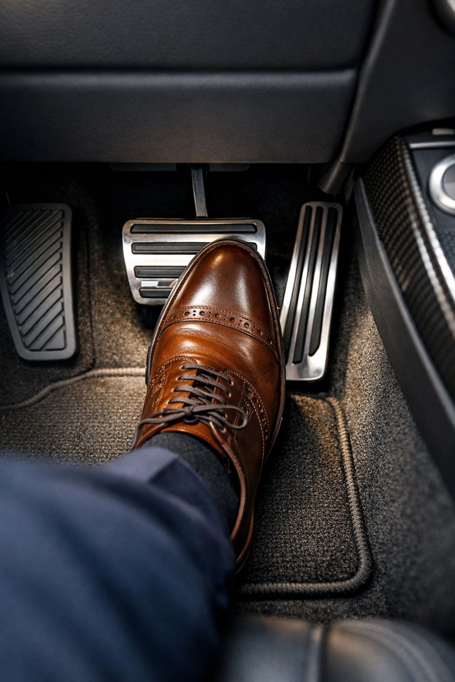 Driver pressing a firm brake pedal, ensuring vehicle safety and responsive braking during transit.