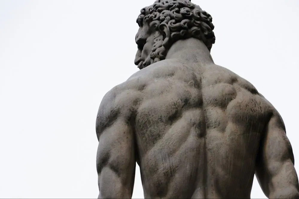 stone-resolve-muscular-male-statue-back.webp