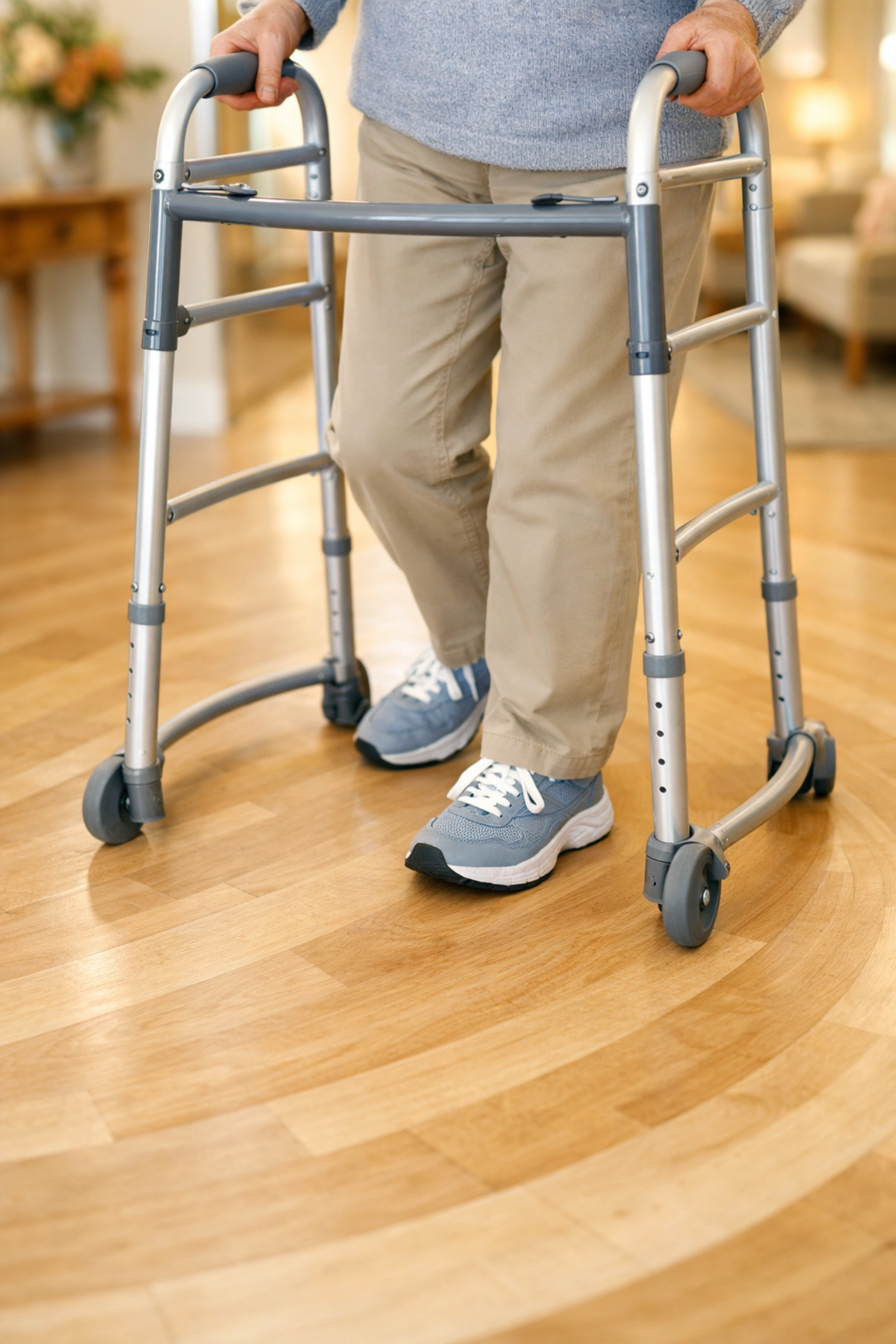 Person taking small marching steps to turn a walker safely inside the frame on a clear floor.