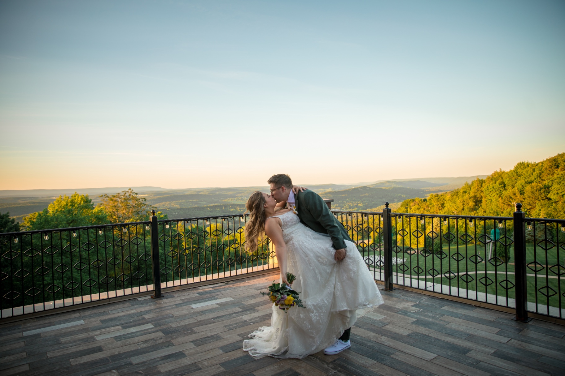 Bride and groom sharing a romantic kiss at golden hour