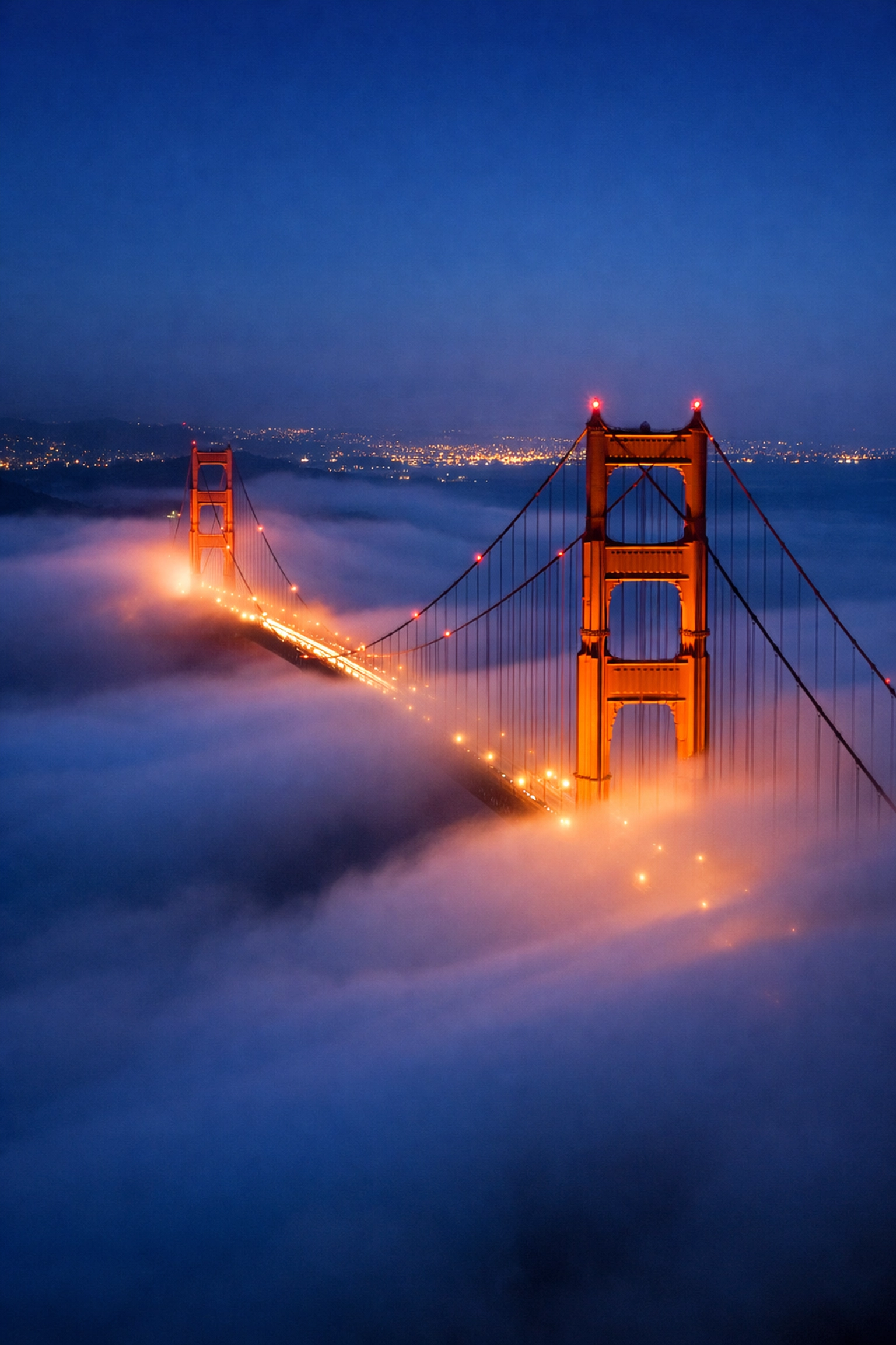 Golden Gate Bridge in San Francisco fog, a prime spot for practicing night travel photography tips.