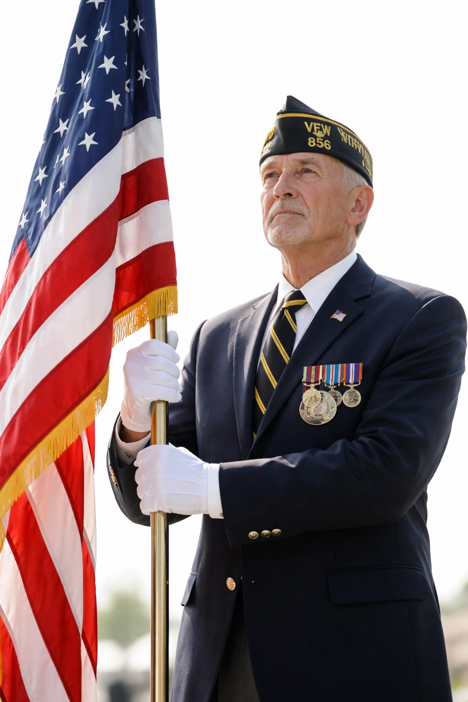Veteran standing at attention with American flag during a memorial ceremony, honoring service and brotherhood