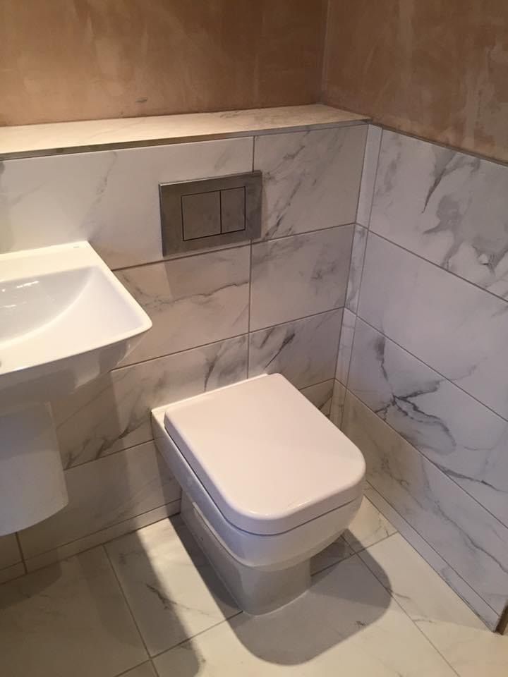 Featuring a wall-hung toilet with concealed cistern and dual flush system