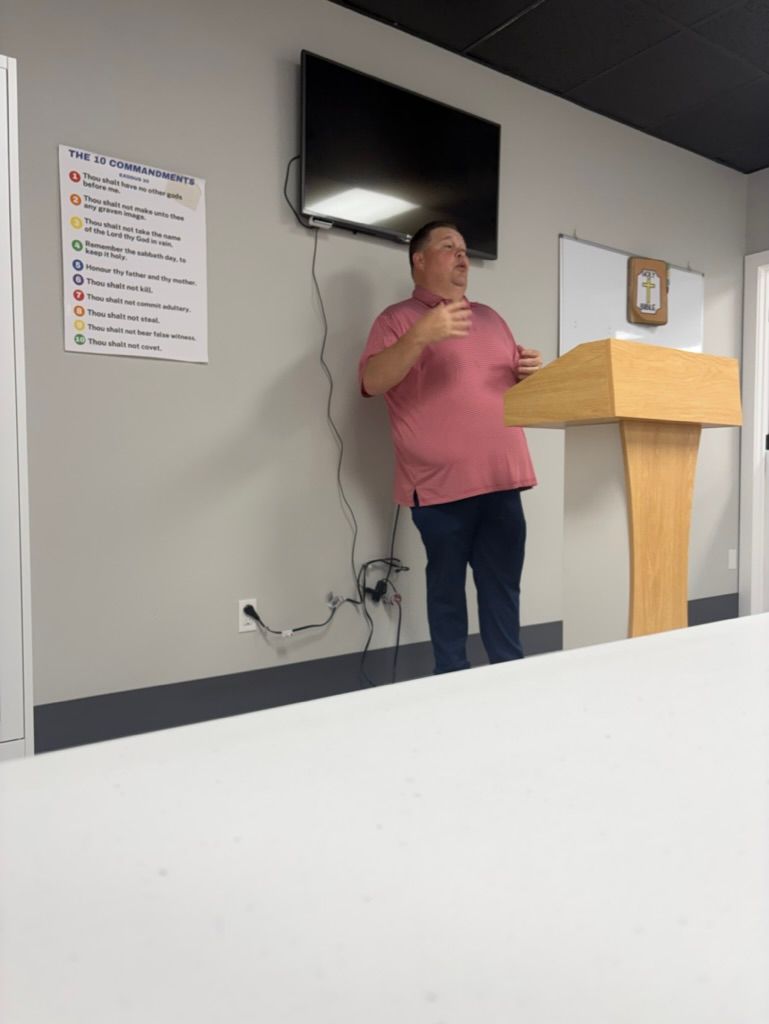 An adult Bible study leader teaching in a classroom at Solid Rock Baptist Church