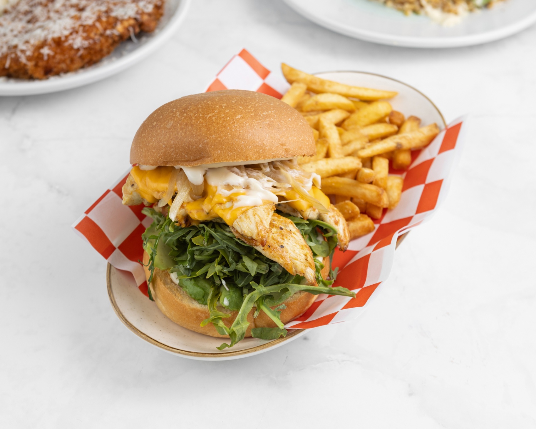 Grilled chicken burger loaded with melted cheese and fresh greens