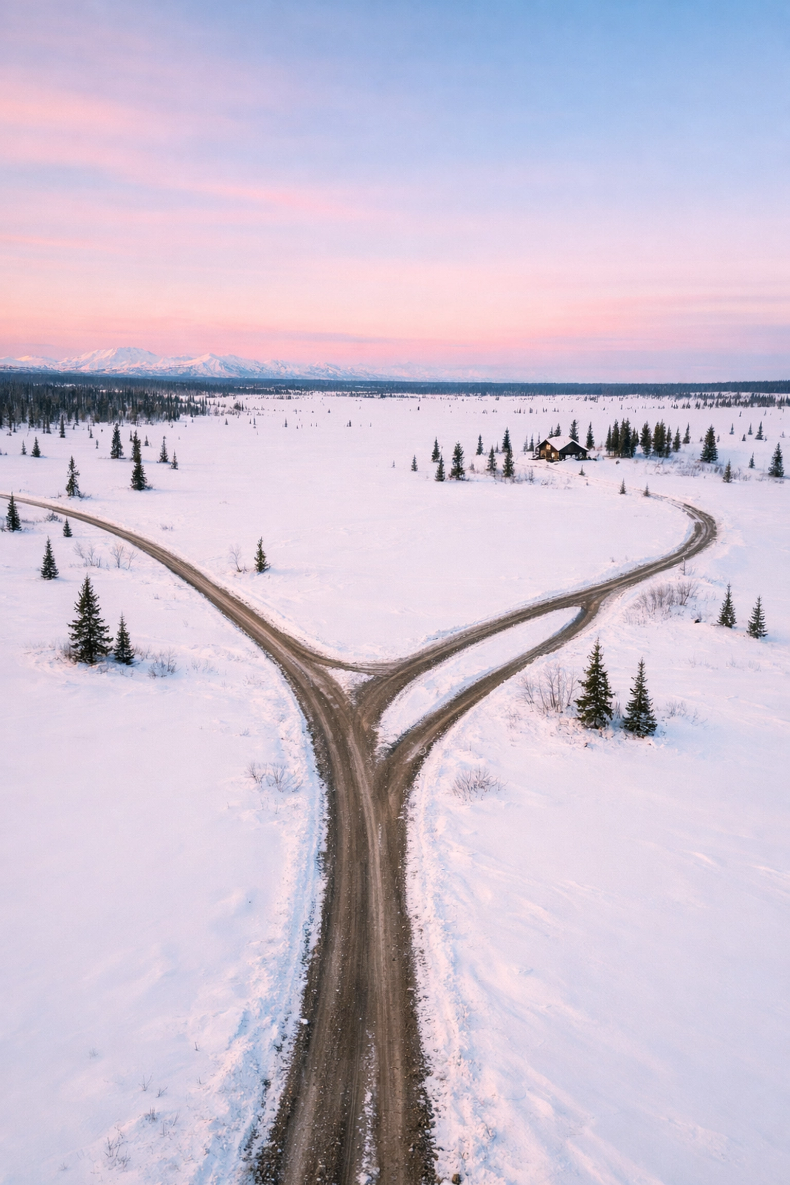 Unmarked winding roads through snowy Alaska wilderness near Delta Junction