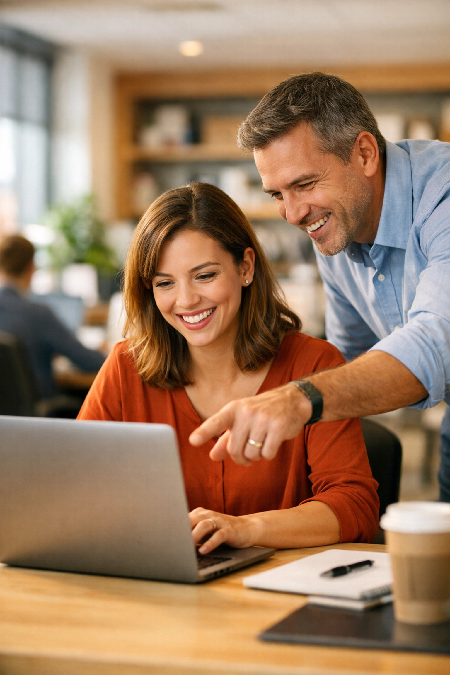 Colleagues collaborating during a ServiceNow AI training session to improve user adoption and change management.