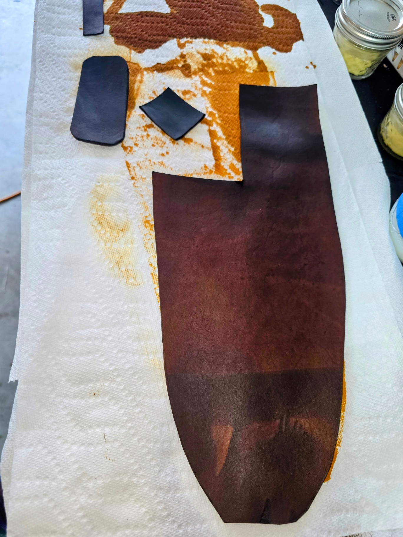 leather pieces freshly dyed leather pieces are drying on a workbench after being freshly dyed