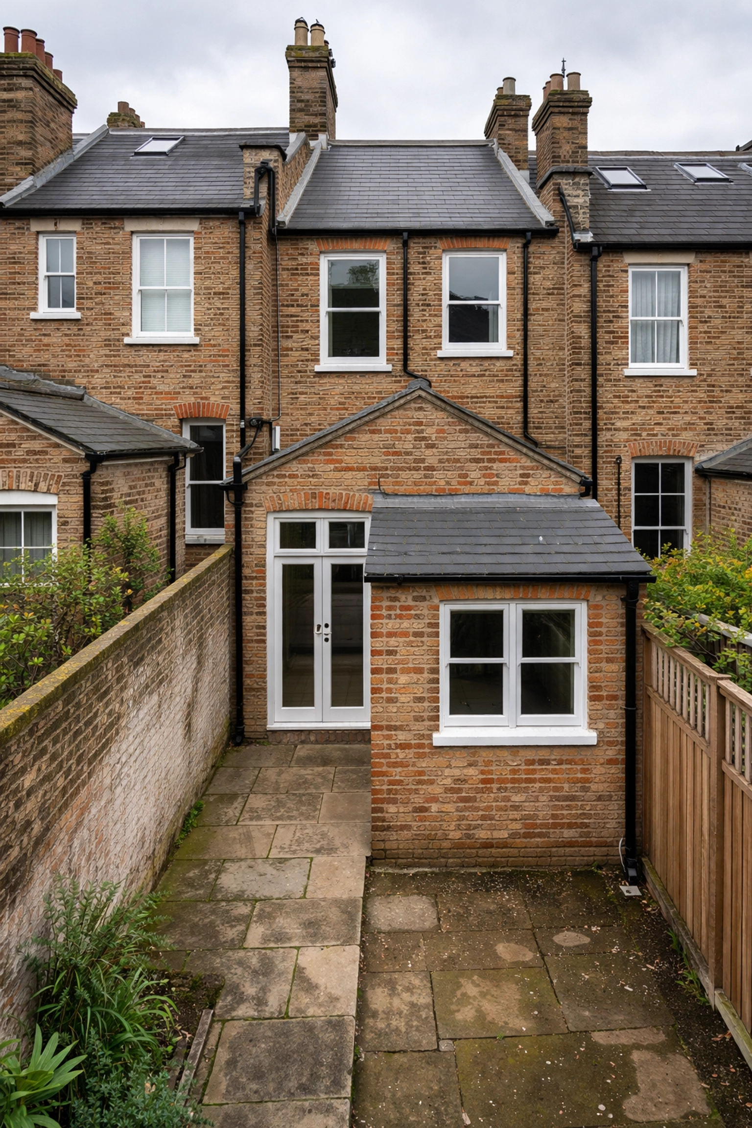 Rear view of a Victorian terraced house in East London showing the narrow side-return passage