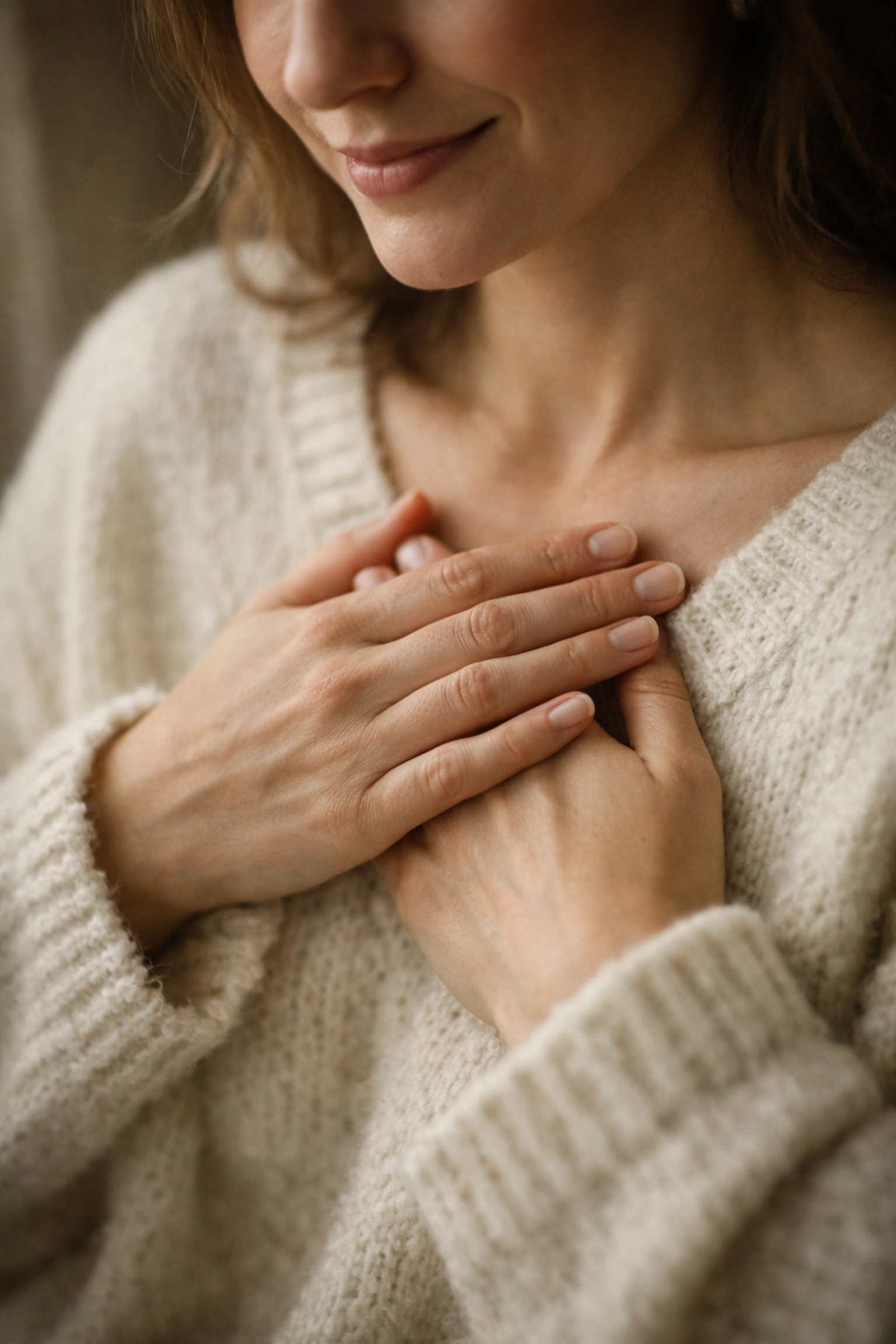 Woman holding hands over heart demonstrating nervous system awareness and HRV connection