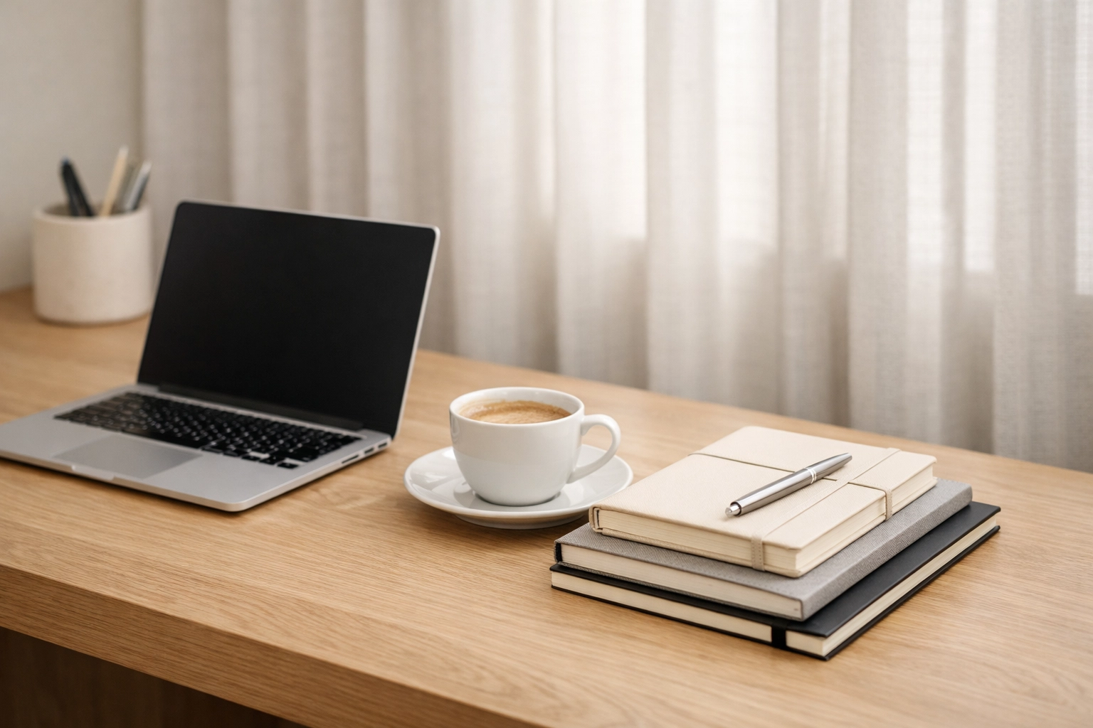 Minimalist hotel office workspace with a laptop representing a clear hotel management software choice.