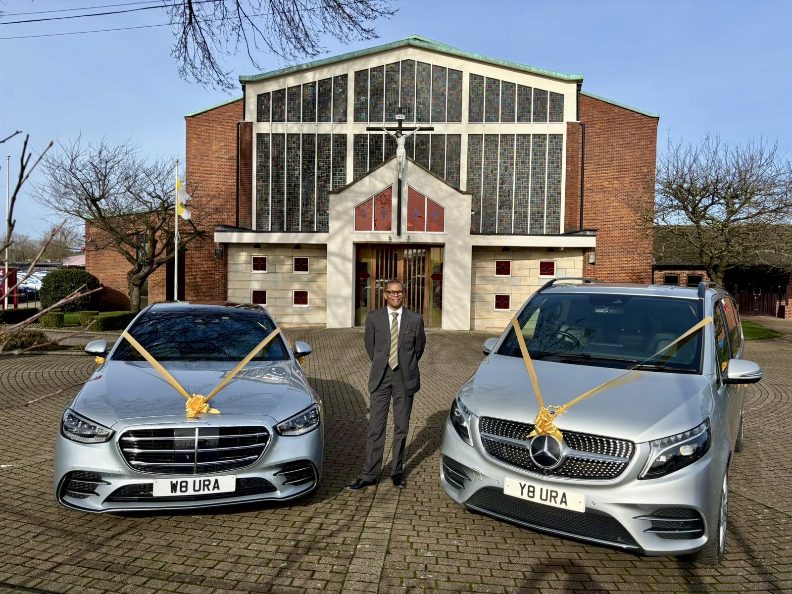 Two silver Mercedes-Benz wedding cars