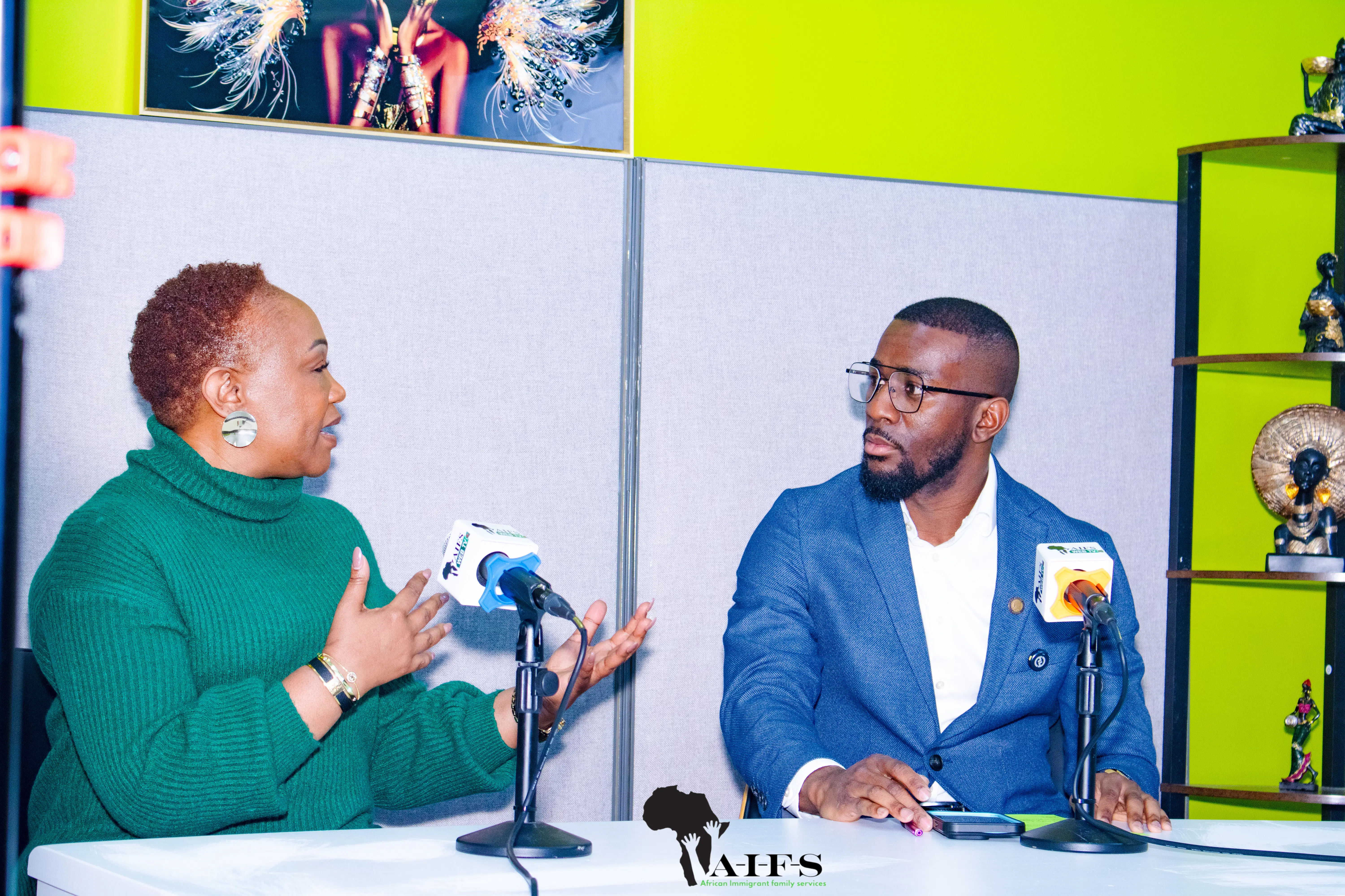 Hosts in the AIFS Web TV studio broadcasting community stories for african immigrant services in Nebraska.