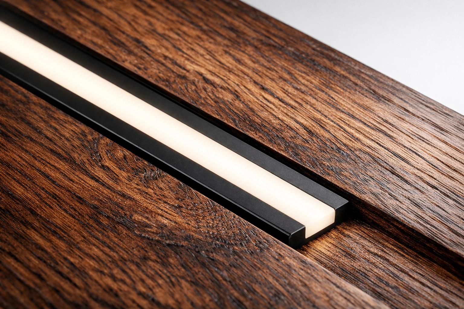 Detailed view of a flush-mounted aluminum linear LED profile in custom woodwork for dot-less lighting.