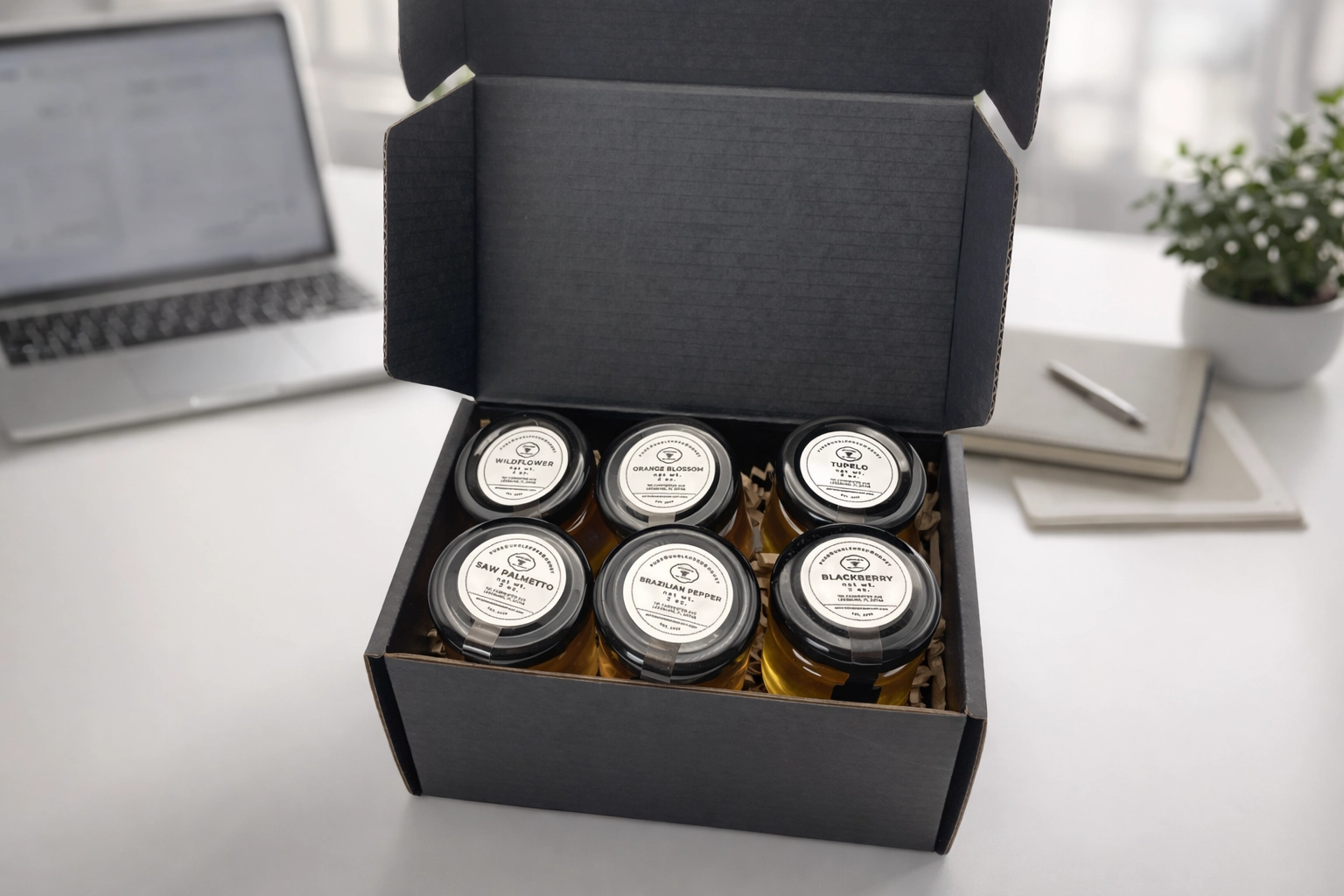 Real Mitchem Bee Company Varietal Raw Honey Sampler gift box with 100% authentic Mitchem Bee Company branding, photographed in a corporate gift setting.