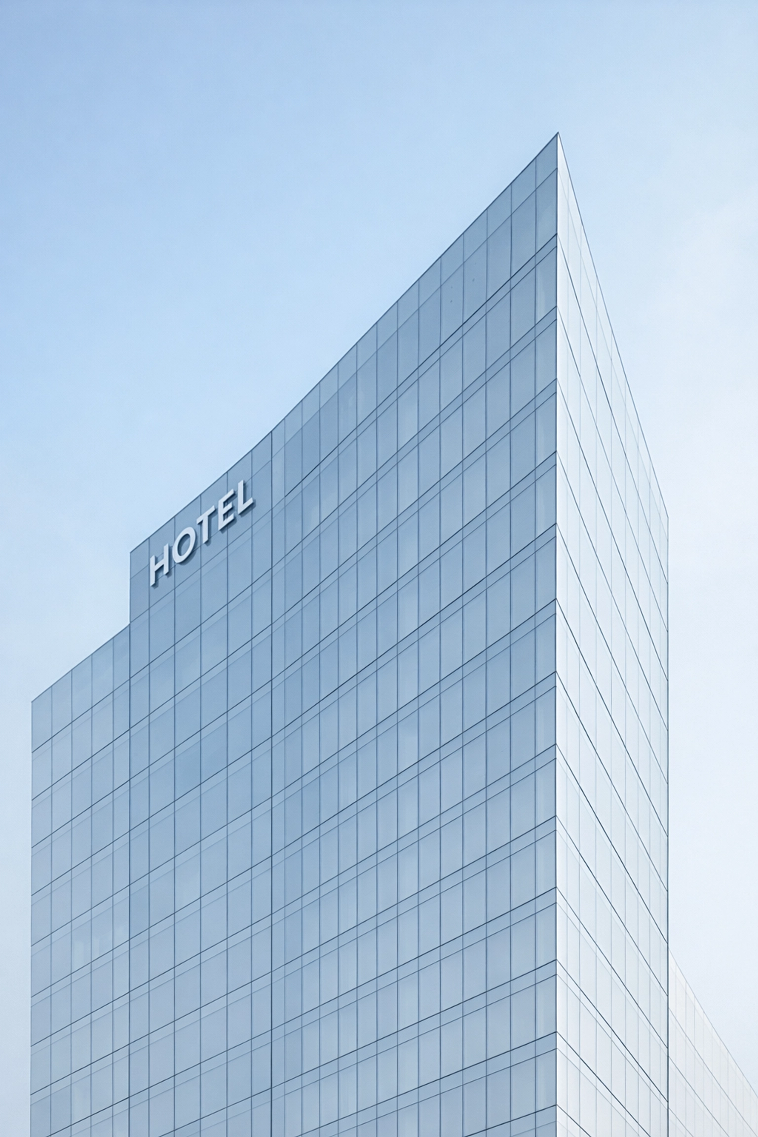 Modern glass hotel building facade symbolizing scalable and future-proof hospitality technology.