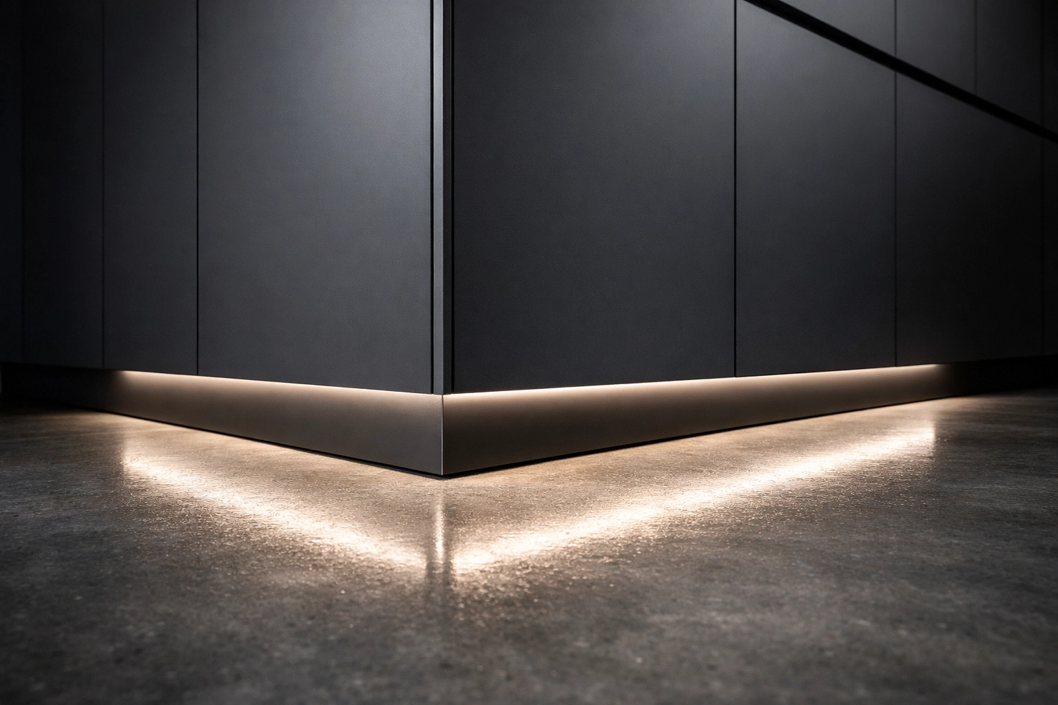 Modern kitchen pantry with LED toe kick lighting creating a floating effect on dark cabinetry.