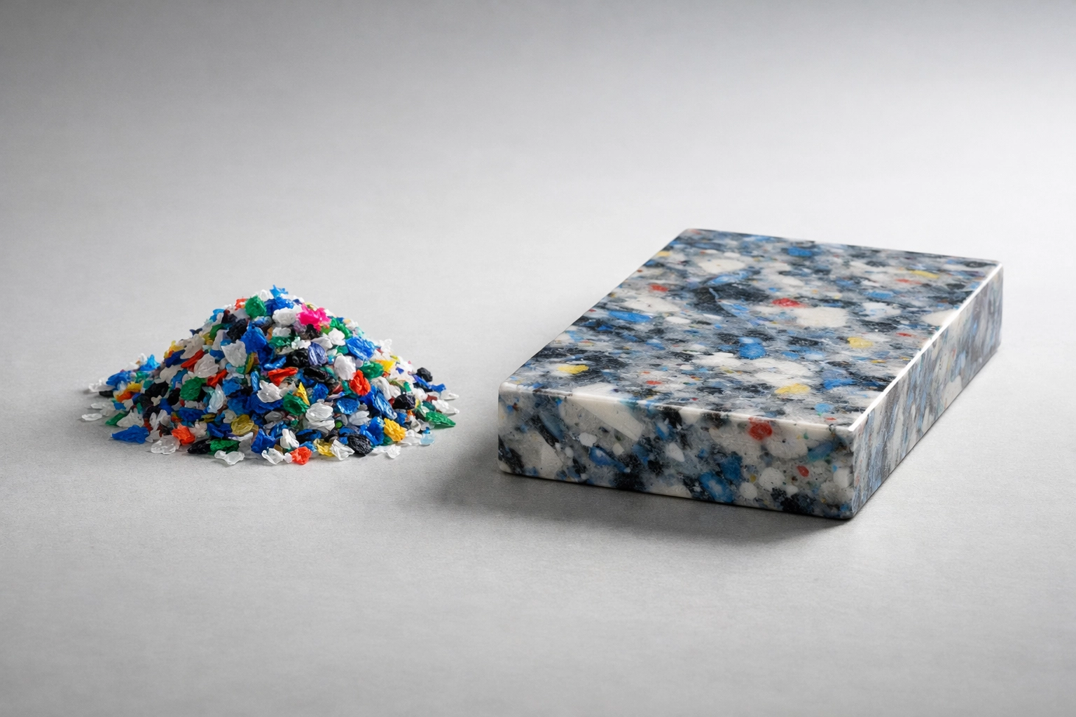 Shredded recycled plastic flakes next to a finished panel, representing circular construction in Australia.