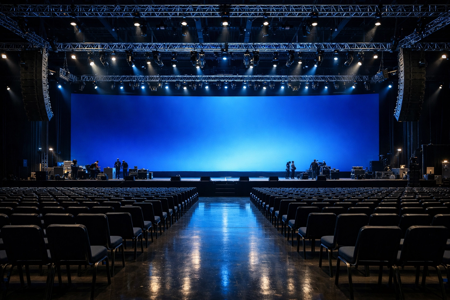 Professional technical execution of a corporate event stage featuring large-scale LED displays and audio systems.