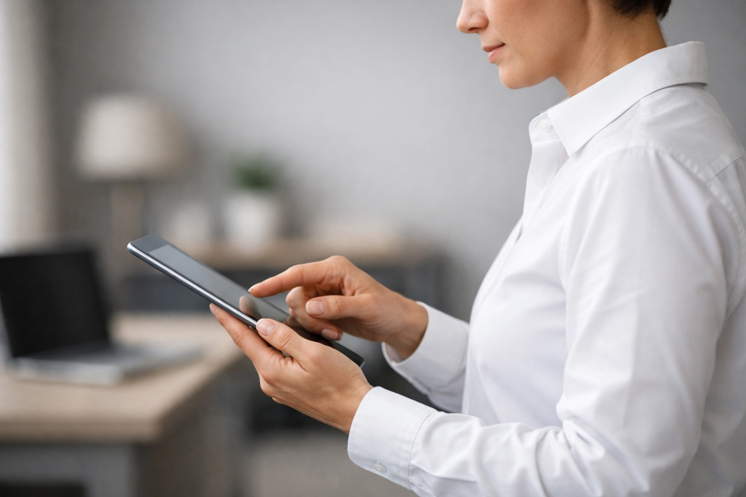 A tax professional using a tablet in a modern office, highlighting secure IRS EFIN management and data protection.