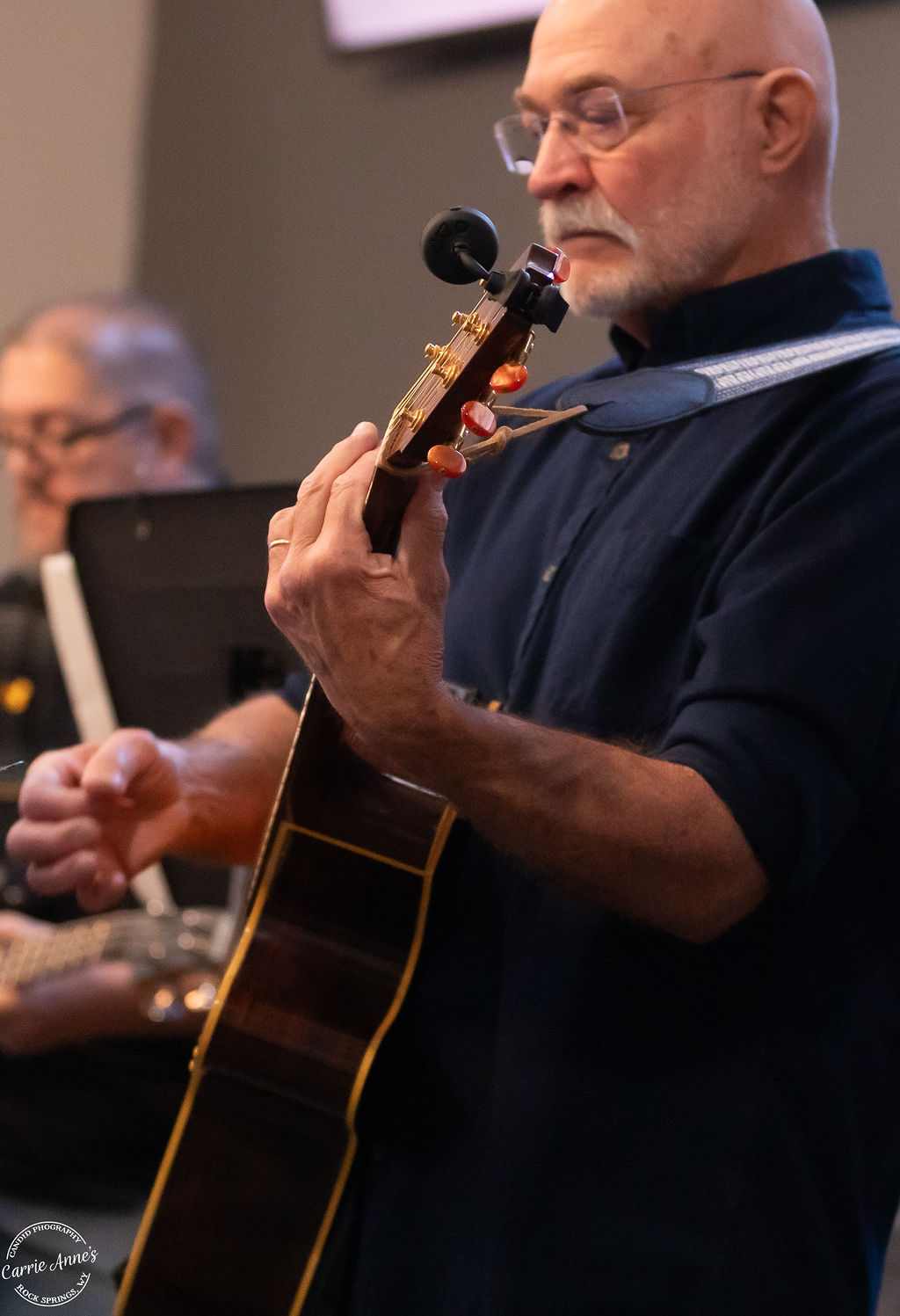 A member of the Green River Alliance Church worship team plays acoustic guitar