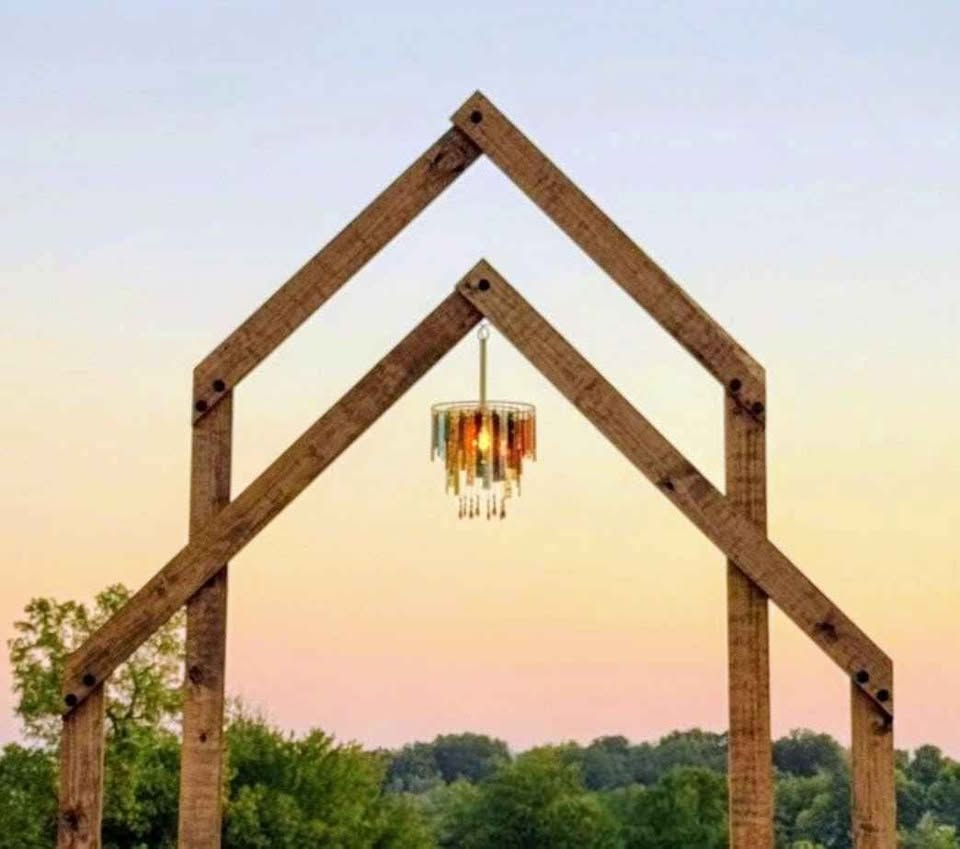 Rustic double wooden arch with chandelier