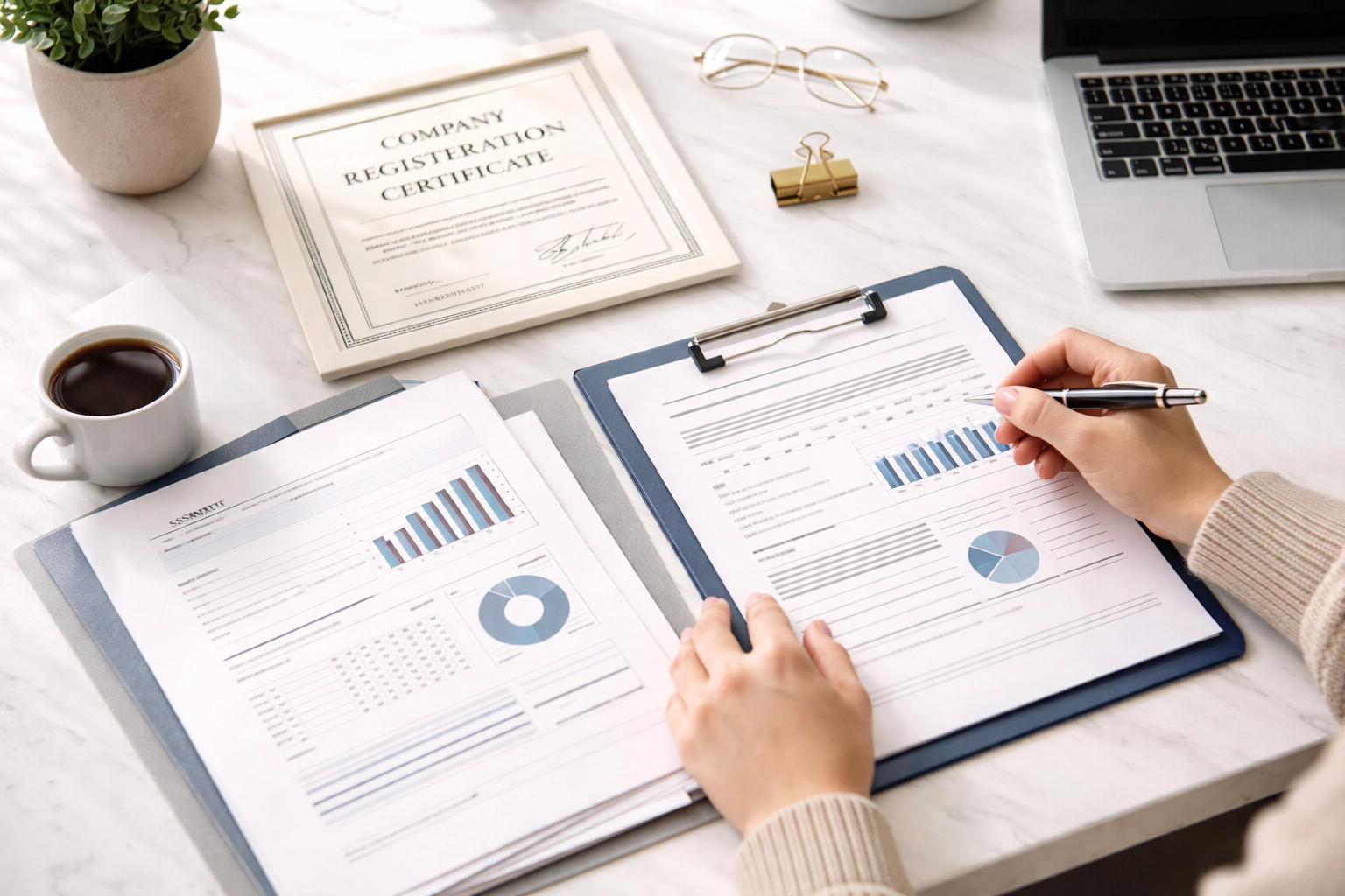 Young entrepreneur reviewing business documents and company registration paperwork, highlighting the importance of legal basics.