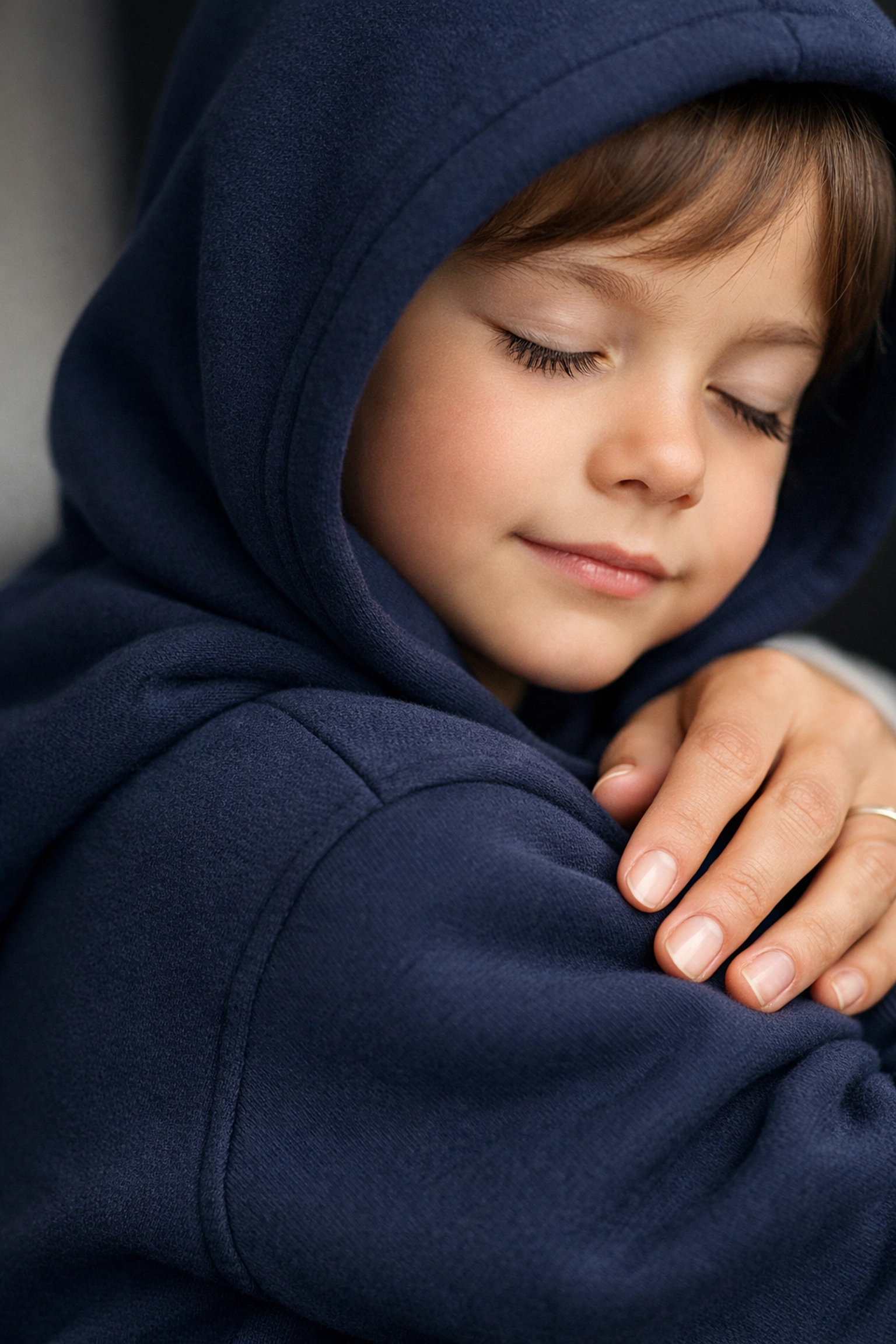 A child in a sensory-friendly hoodie, showing the calming deep-pressure effect of therapeutic clothing.