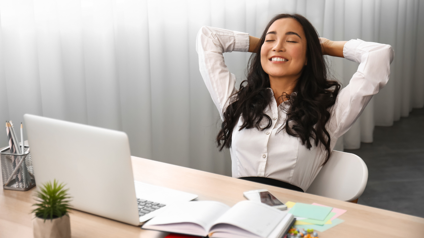 A real estate manager relaxes at her desk
